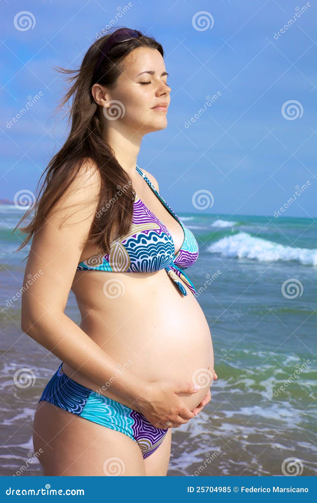 Pregnant Woman Holding Belly In Fron