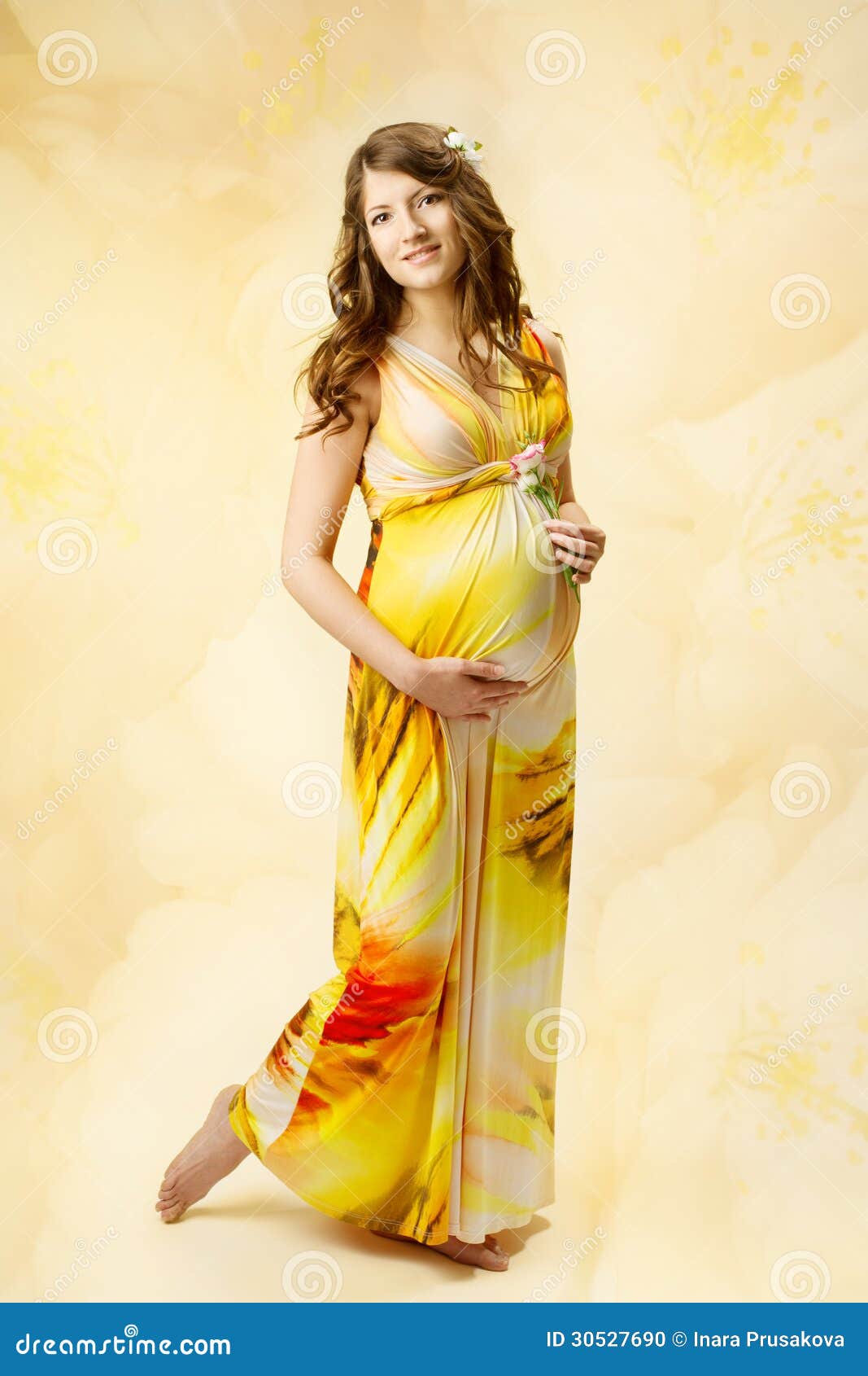 Pregnant Woman In Long Dress Over Yellow Art Background 