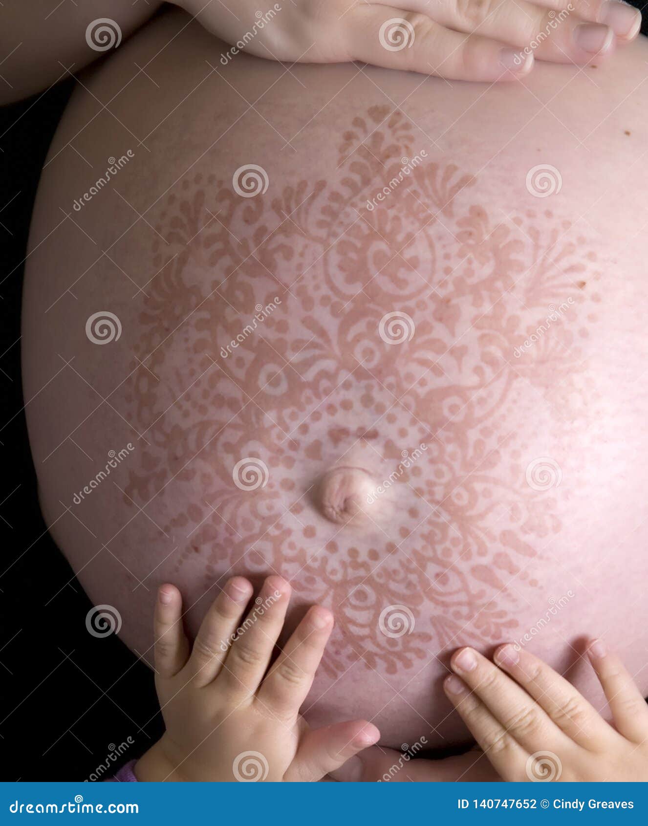 Pregnant Woman`s Belly with Henna Tattoo and Child`s Hands Stock Photo -  Image of childs, button: 140747652
