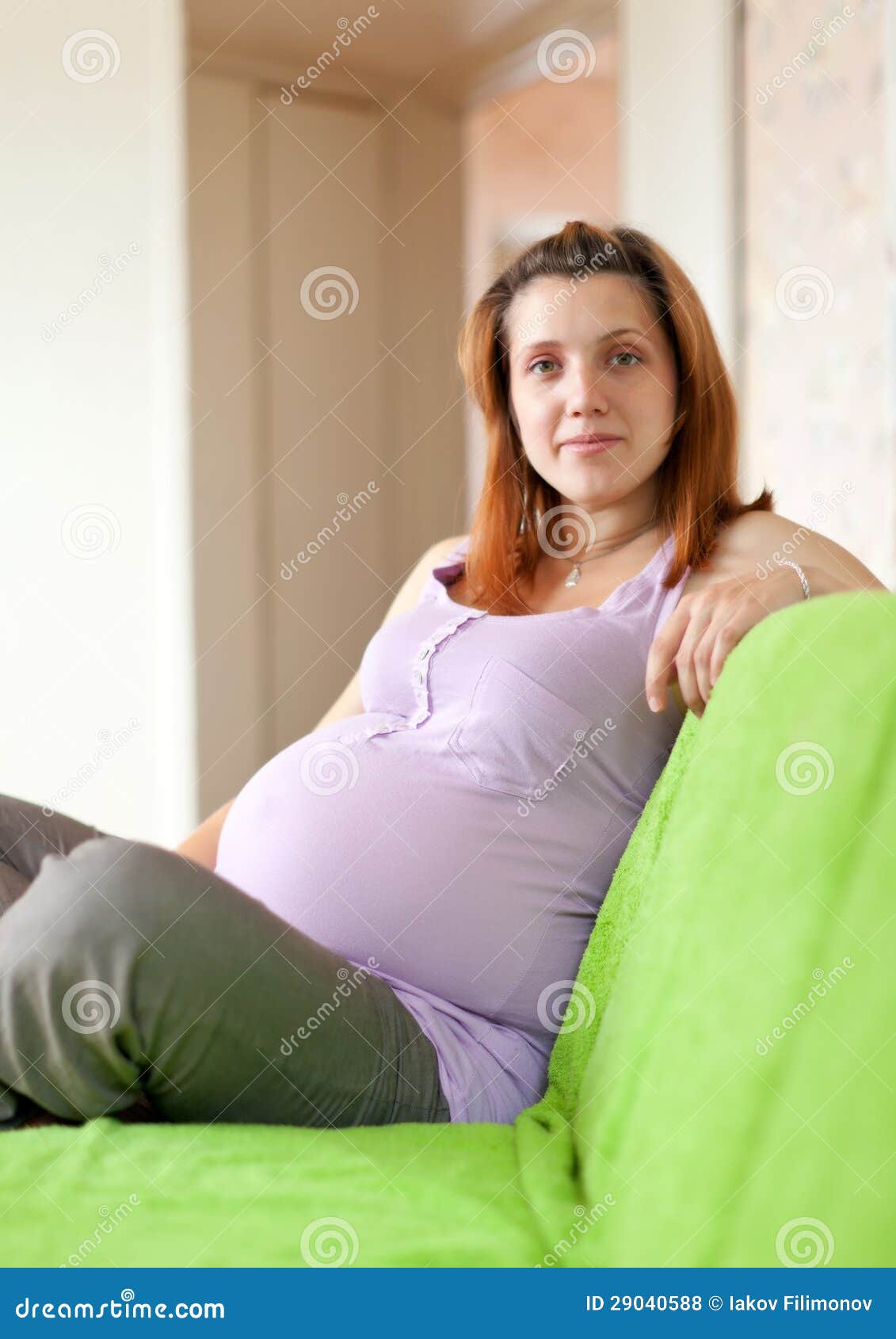 Pregnant woman on sofa stock photo. Image of lifestyles 29040588