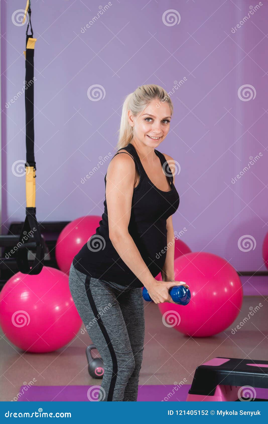 Pregnant Woman Stand In The Gym Holding Her Weights On 9