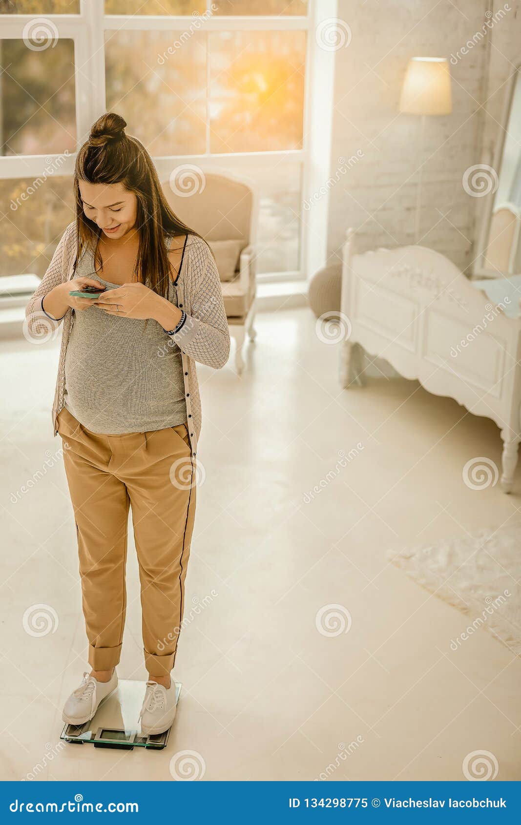 Pregnant Woman Standing on the Weights and Recording Her Weight Stock ...