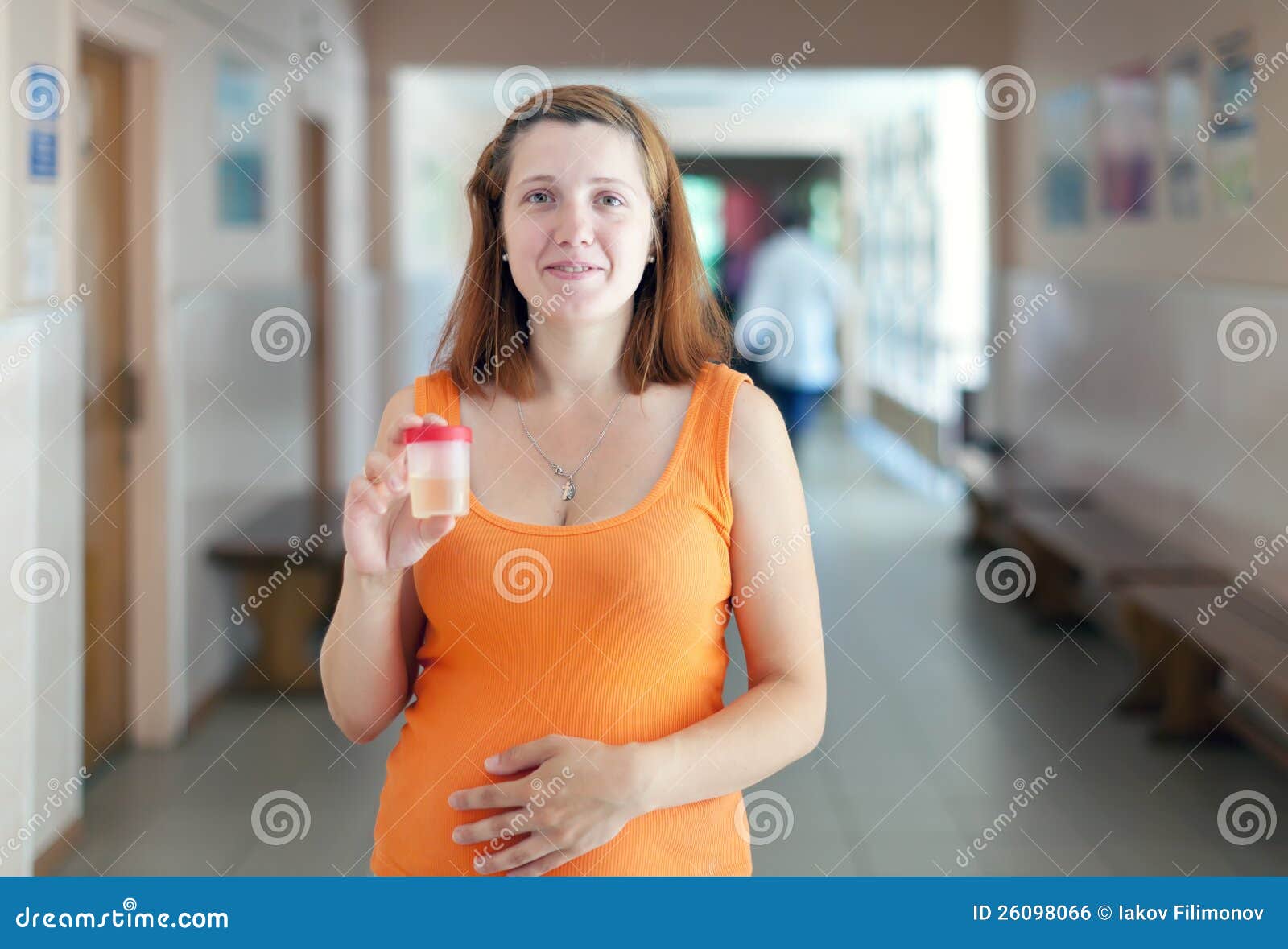 pregnant woman with urinalysis sample