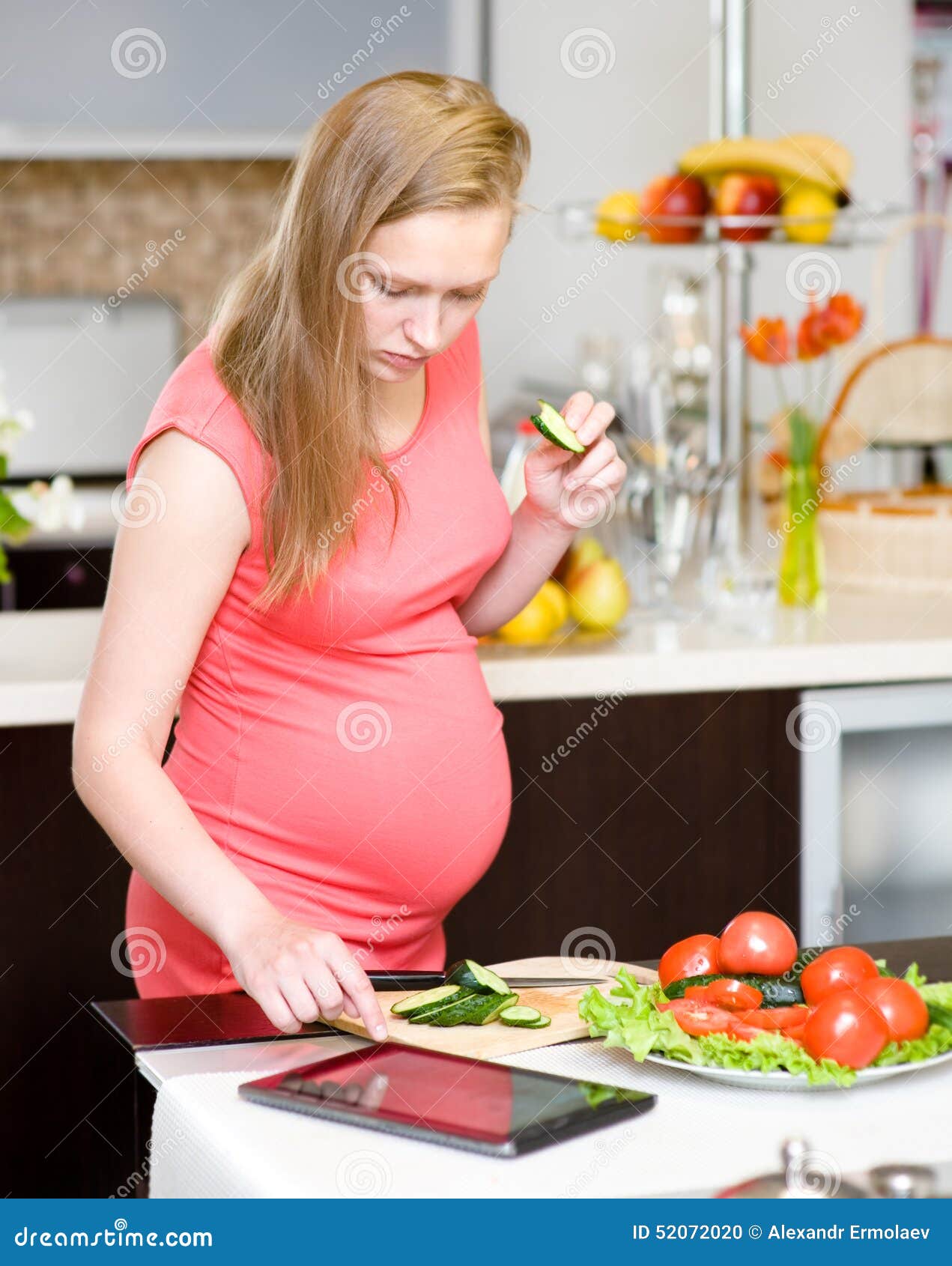 In Kitchen Using Tablet Computer Using A Tablet Computer To Cook In