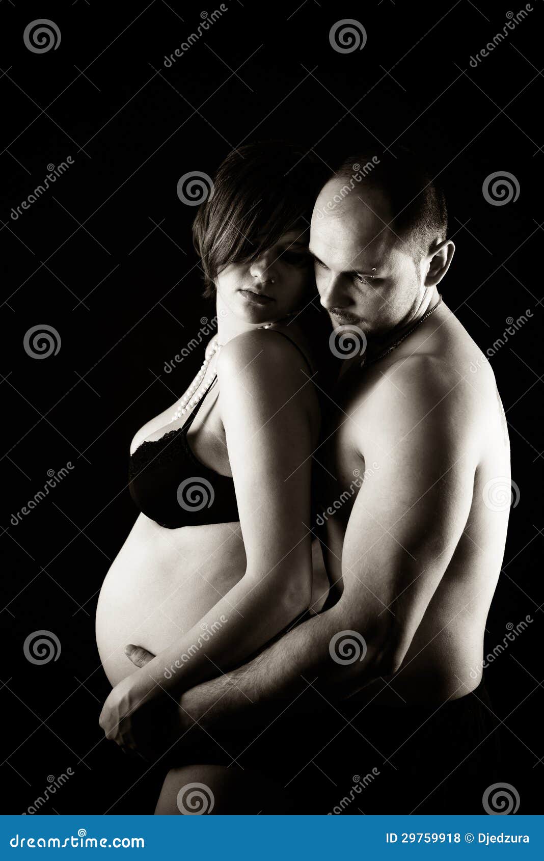 Pregnant Woman and Her Husband in Studio Stock Photo