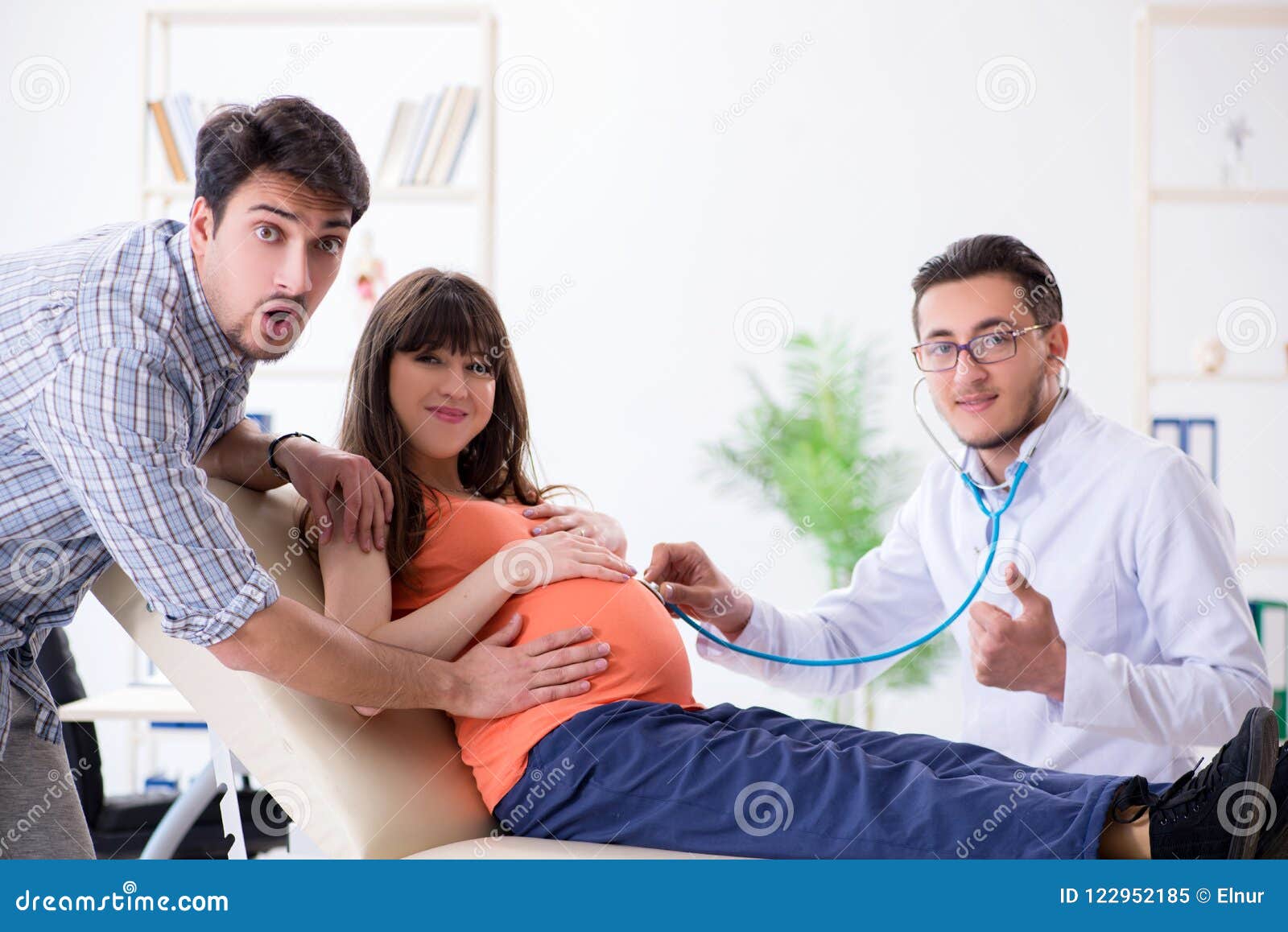 The Pregnant Woman With Her Husband Visiting The Doctor In Clinic Stock 