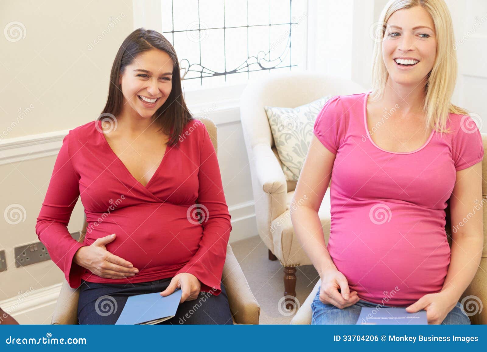 Pregnant Women Meeting At Ante Natal Class Looking Away From Camera smiling