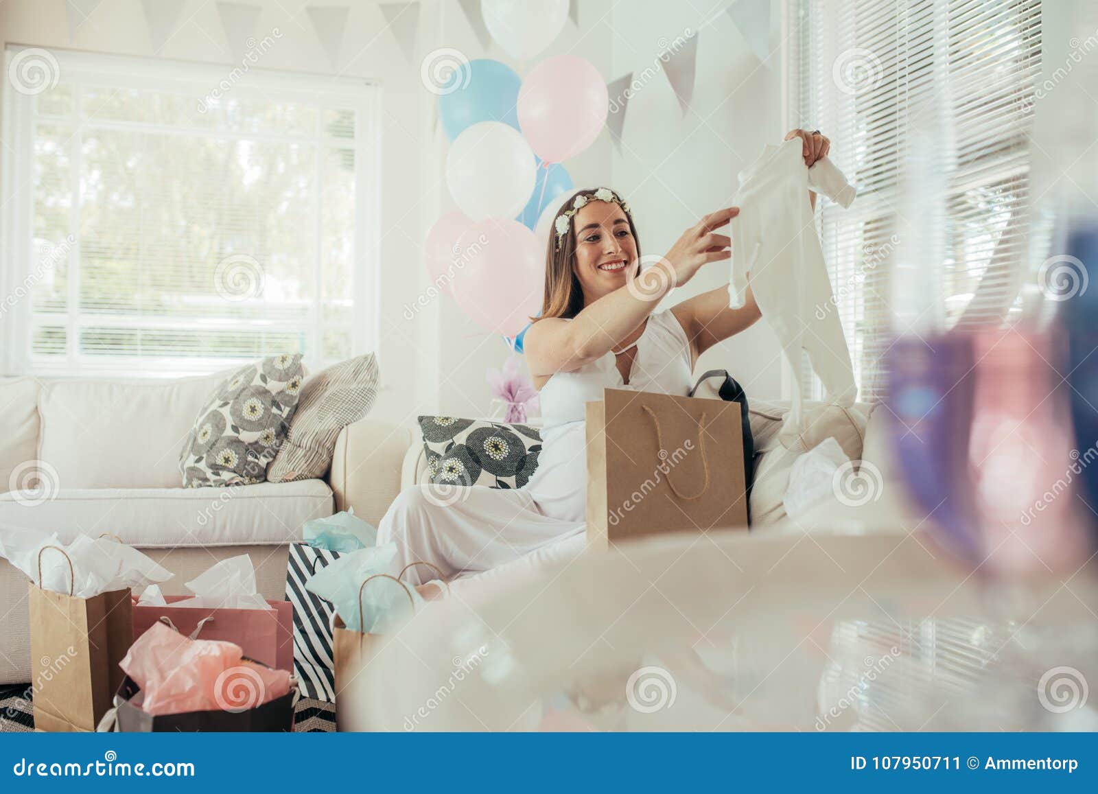 Pregnant Woman Opening A New Gift After Baby Shower Stock ...