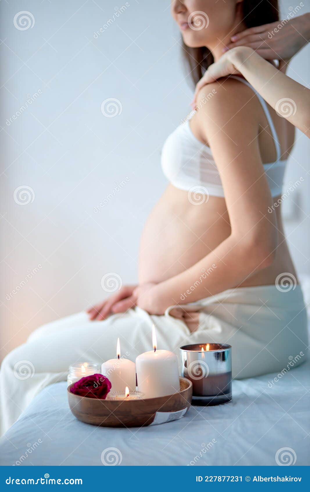 Pregnant Woman Receiving Back Massage From Masseur In Spa Cabinet Sit With Candles Stock Image