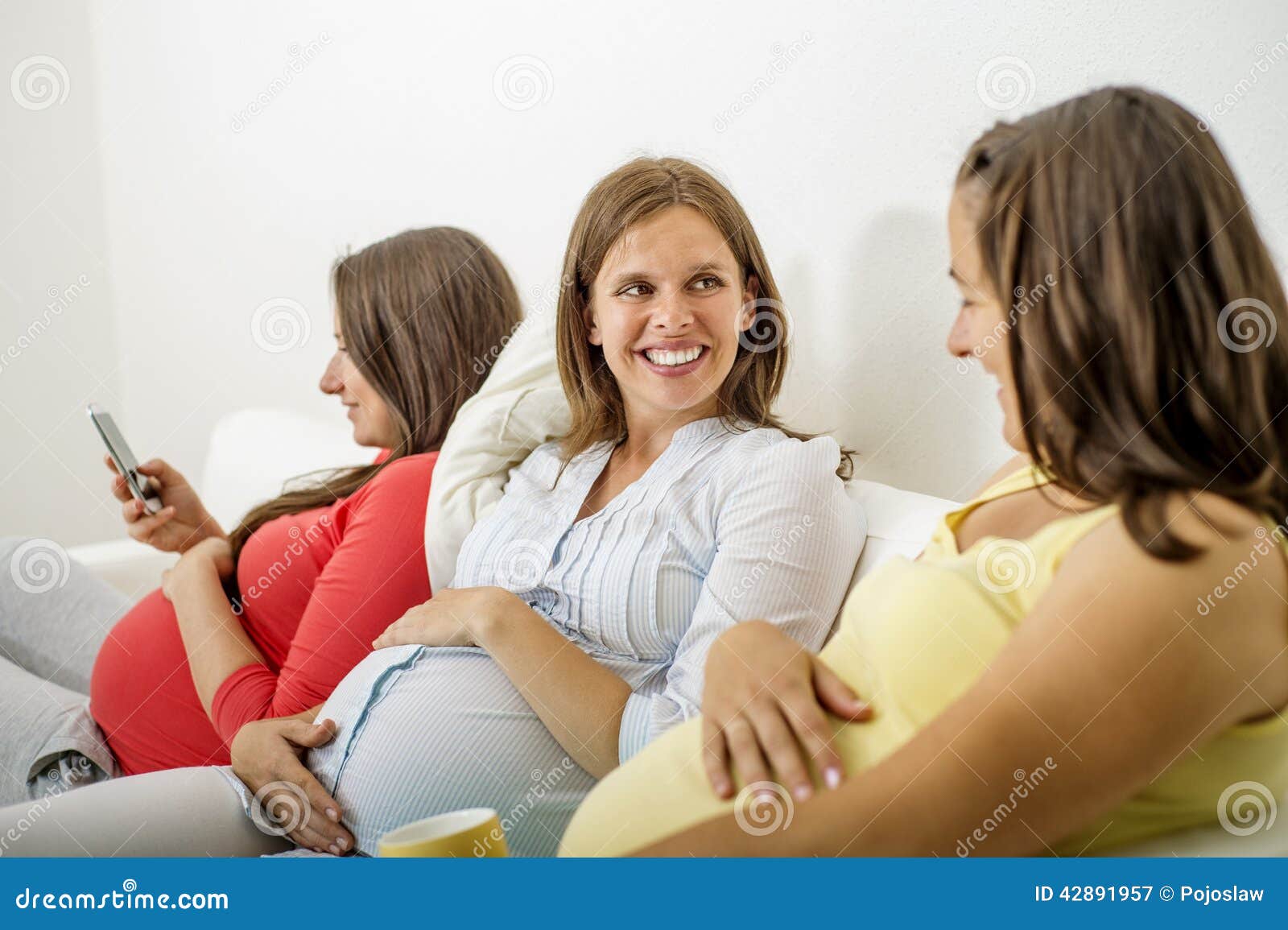 Pregnant women on sofa stock image. Image of chatting 42891957