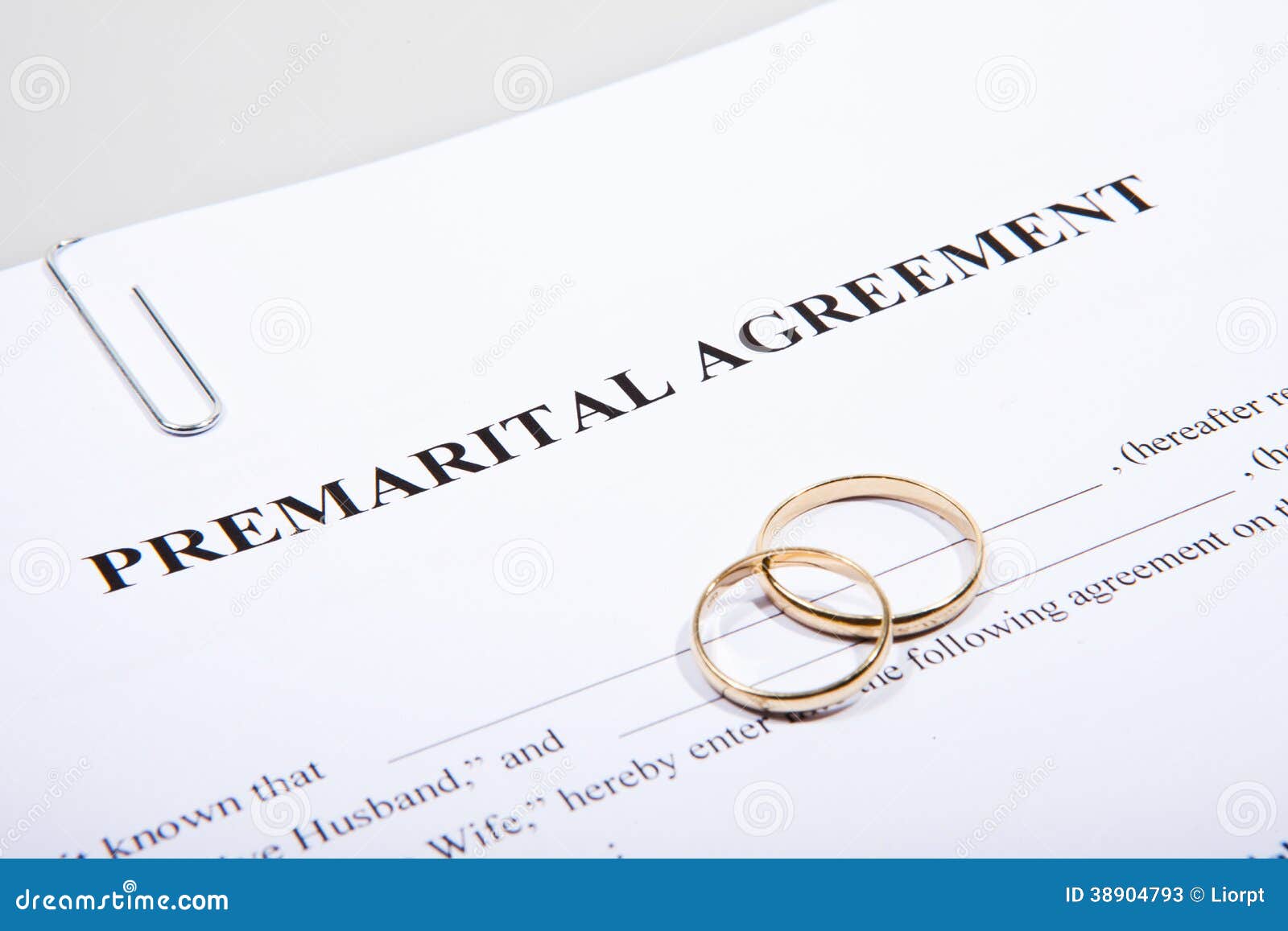 prenuptial agreement form and two wedding rings
