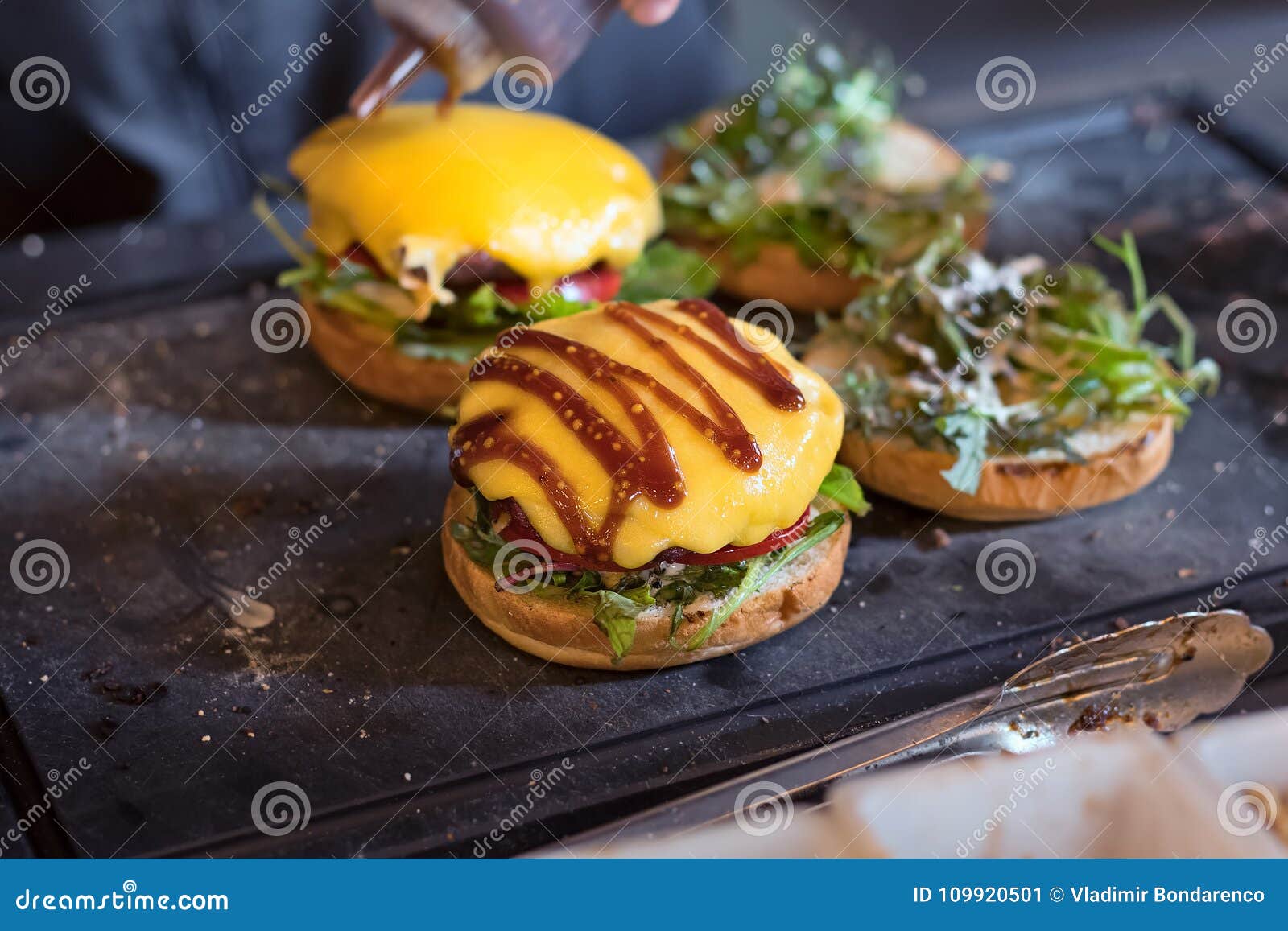 Preparing Burger Adding the Sauce on the Cream Cheese. Three Burgers