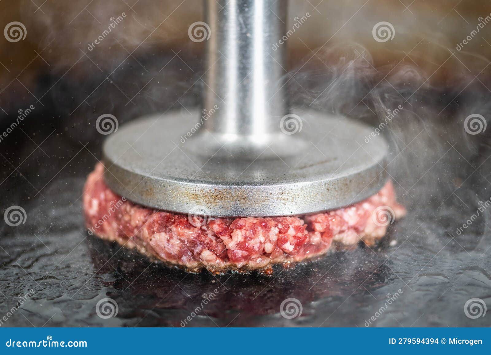 Preparing Burger Patties on the Grill Using Burger Smasher Stock Photo