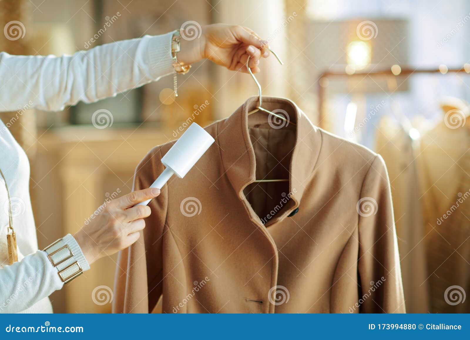 Closeup on Female Cleaning Coat on Hanger with Lint Roller Stock Photo -  Image of handle, portrait: 173994880