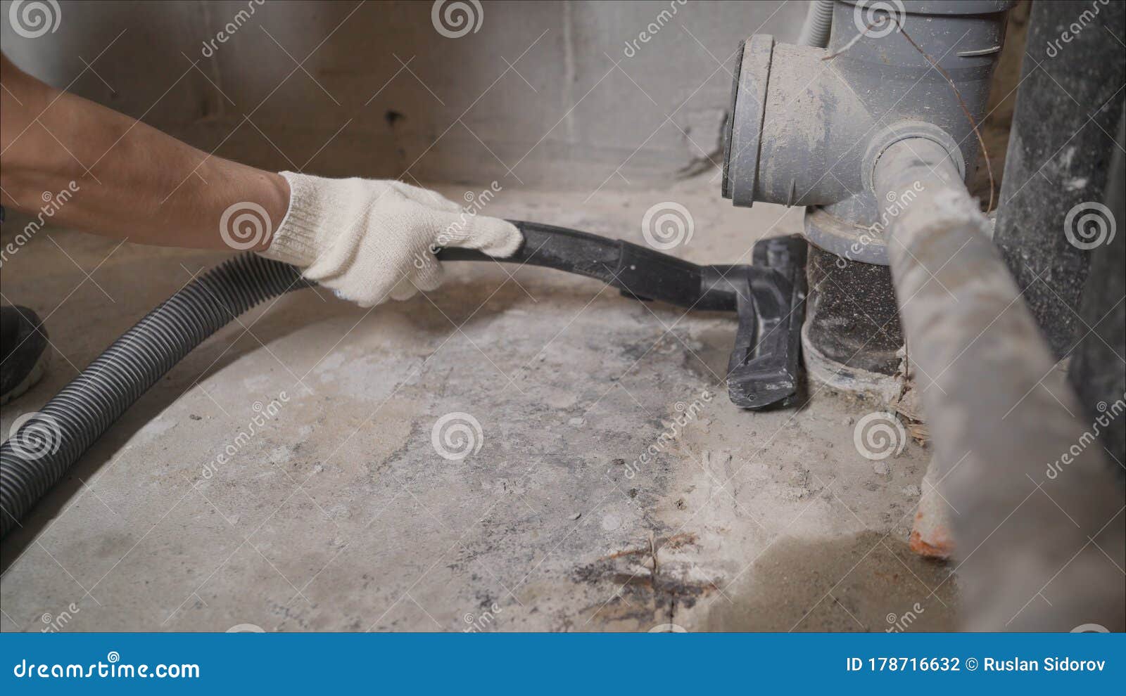Worker Vacuuming Concrete Floors. Preparing the Floor for Waterproofing