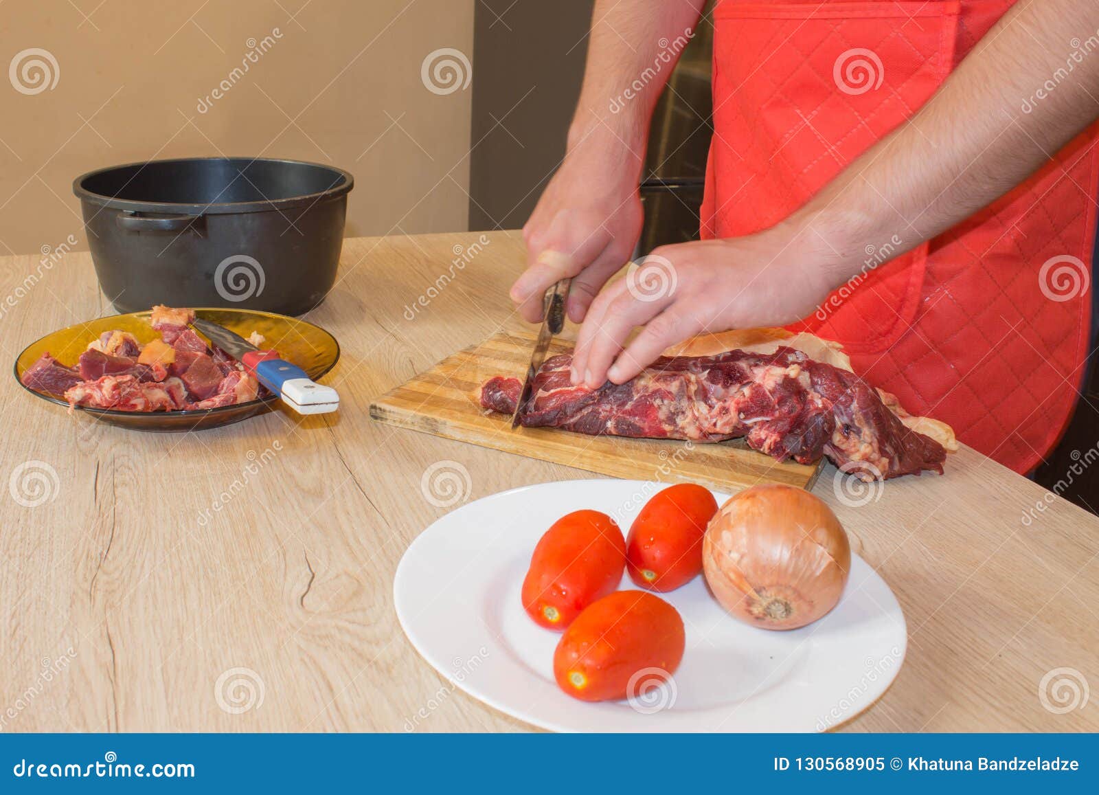 Preparing Meal, Meat and Vegetables. Chef Cutting Meat on Cutting Board