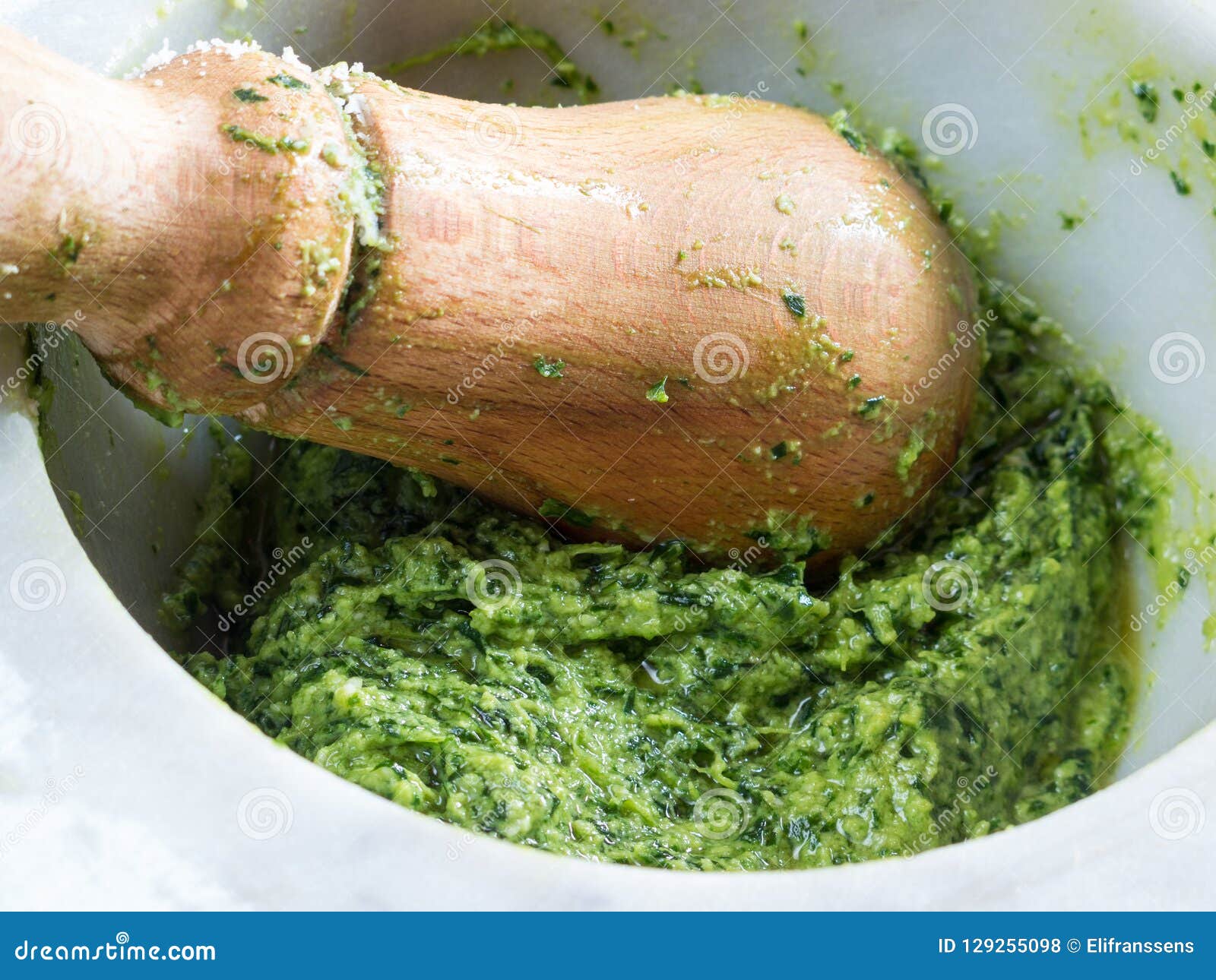 Preparing pesto in mortar stock photo. Image of home 129255098