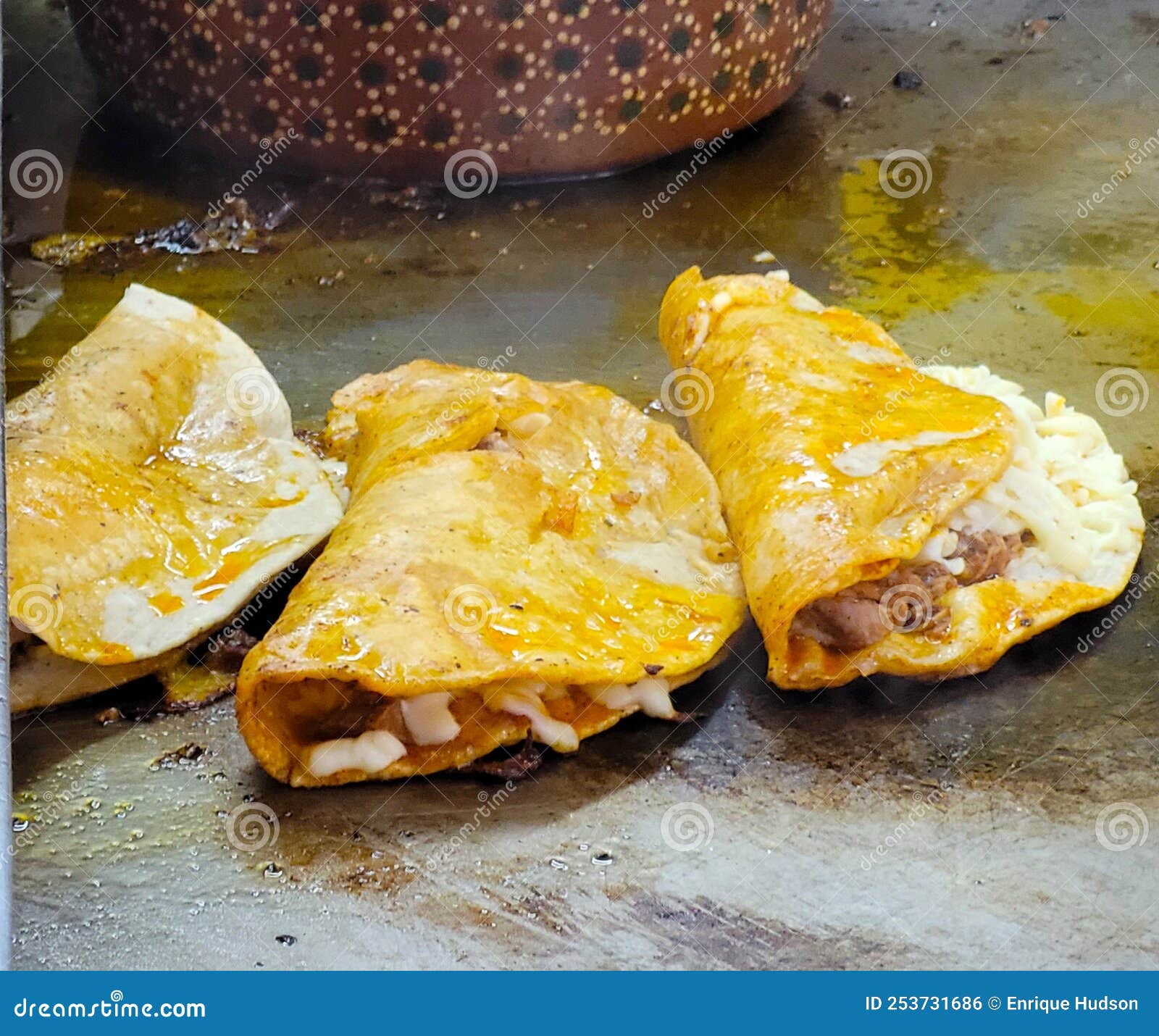 Preparing Some Fried Quesadillas on the Grill in the Market Stock Photo