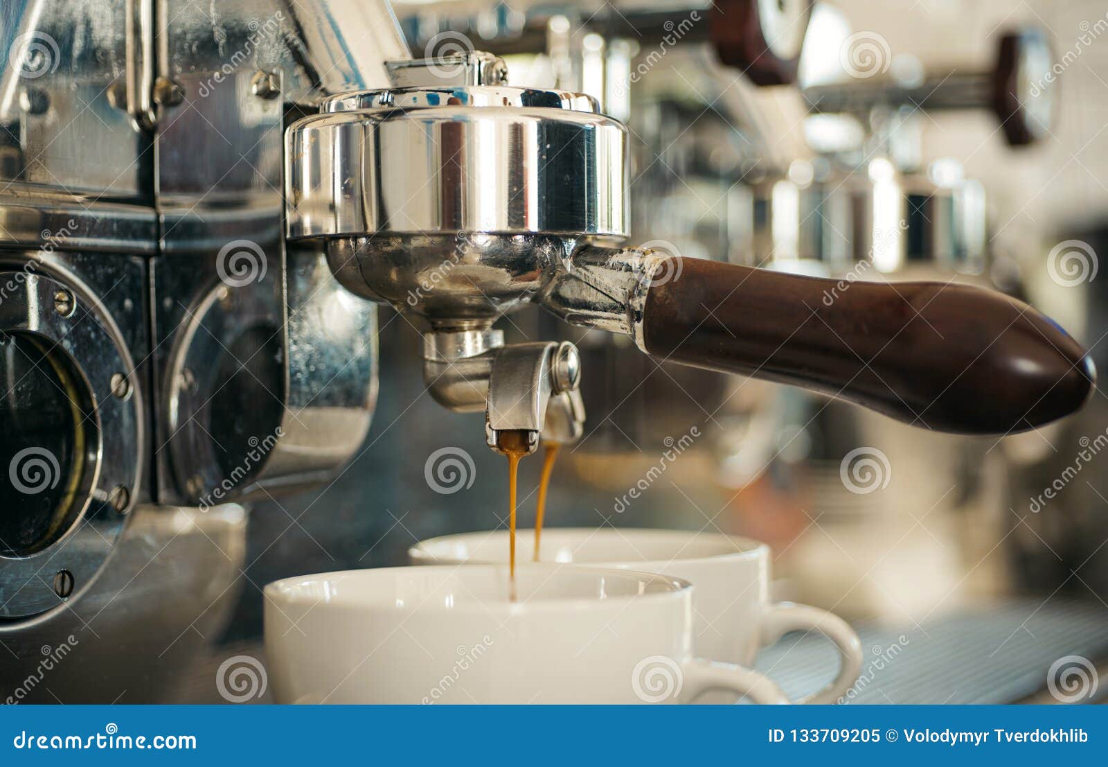 preparing to perfection. small cups to serve hot coffee drinks. coffee cups. coffee being brewed in coffeehouse or cafe