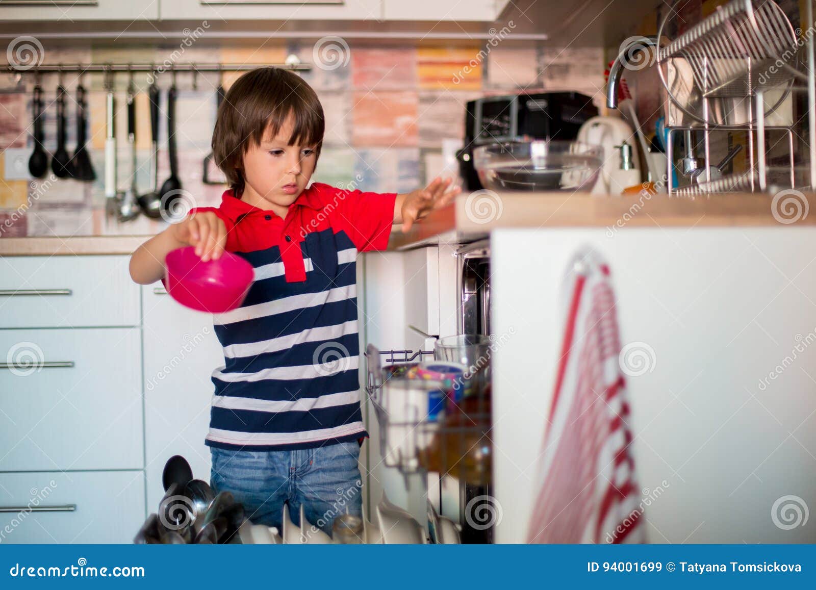 Preschool Child Boy Helping Mom Putting Dirty Dishes In Dishwasher