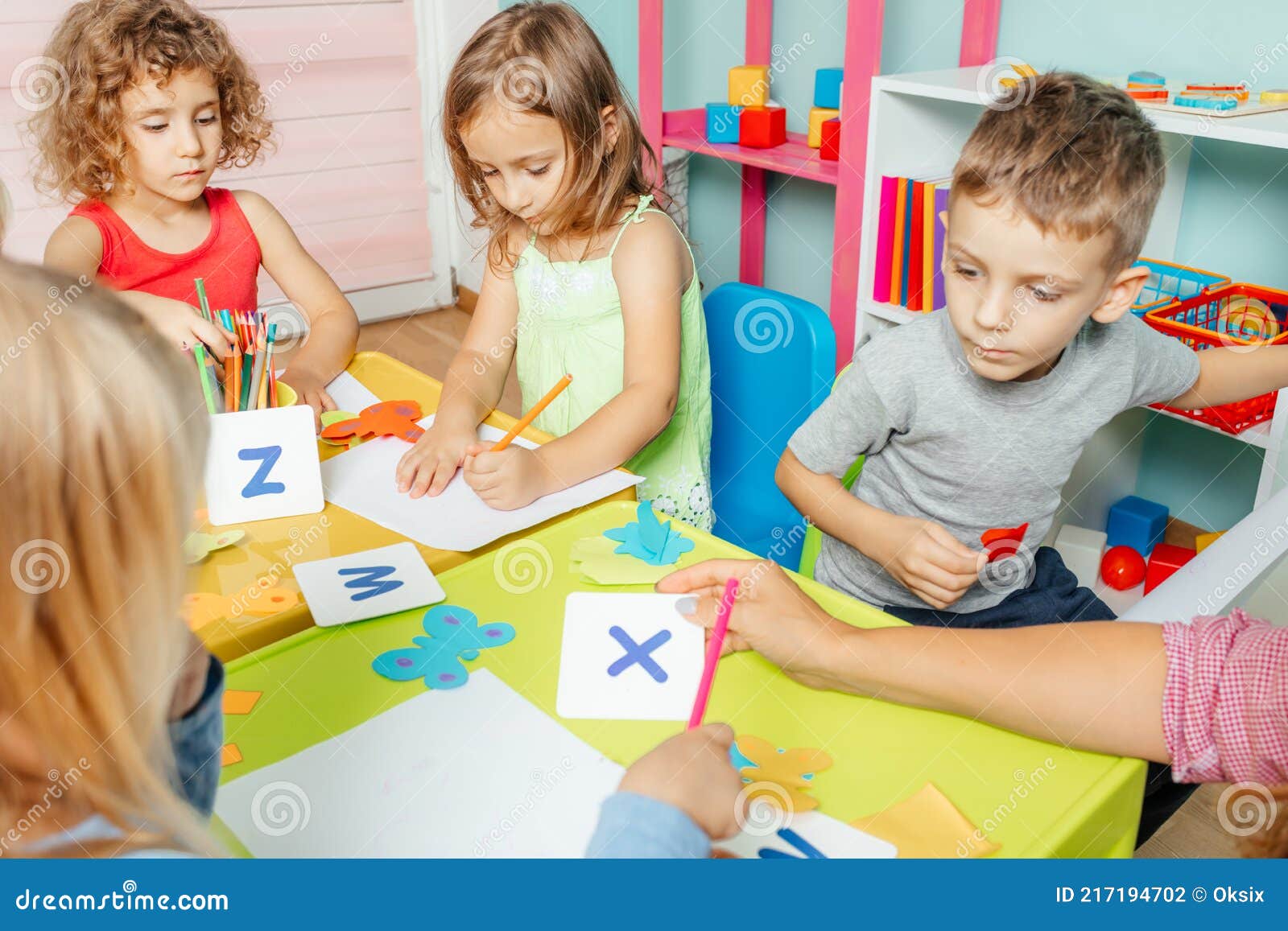Preschool Children Learn English Alphabet Using Cards Stock Photo