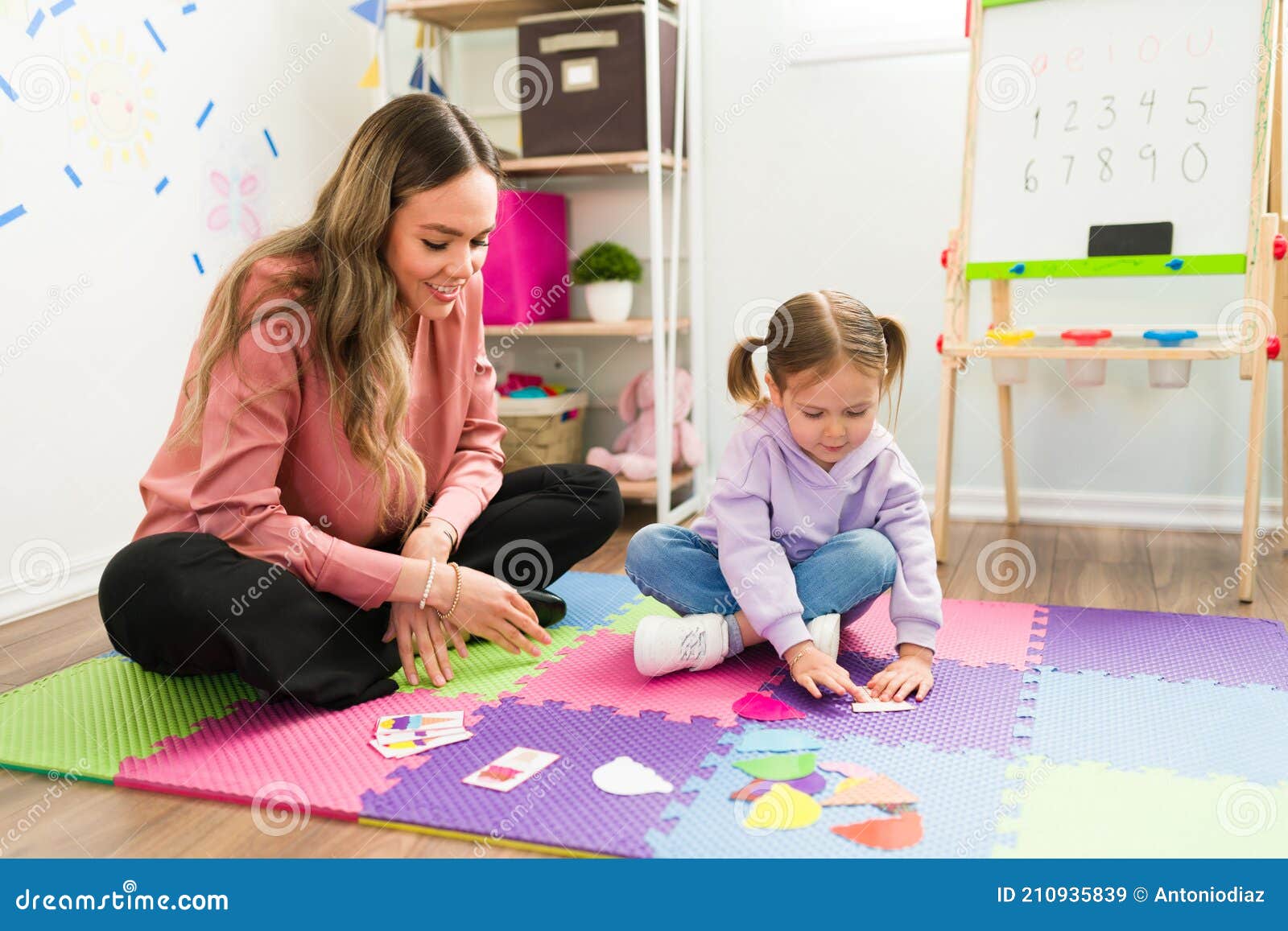 preschool girl doing a puzzle at a child`s therapist office