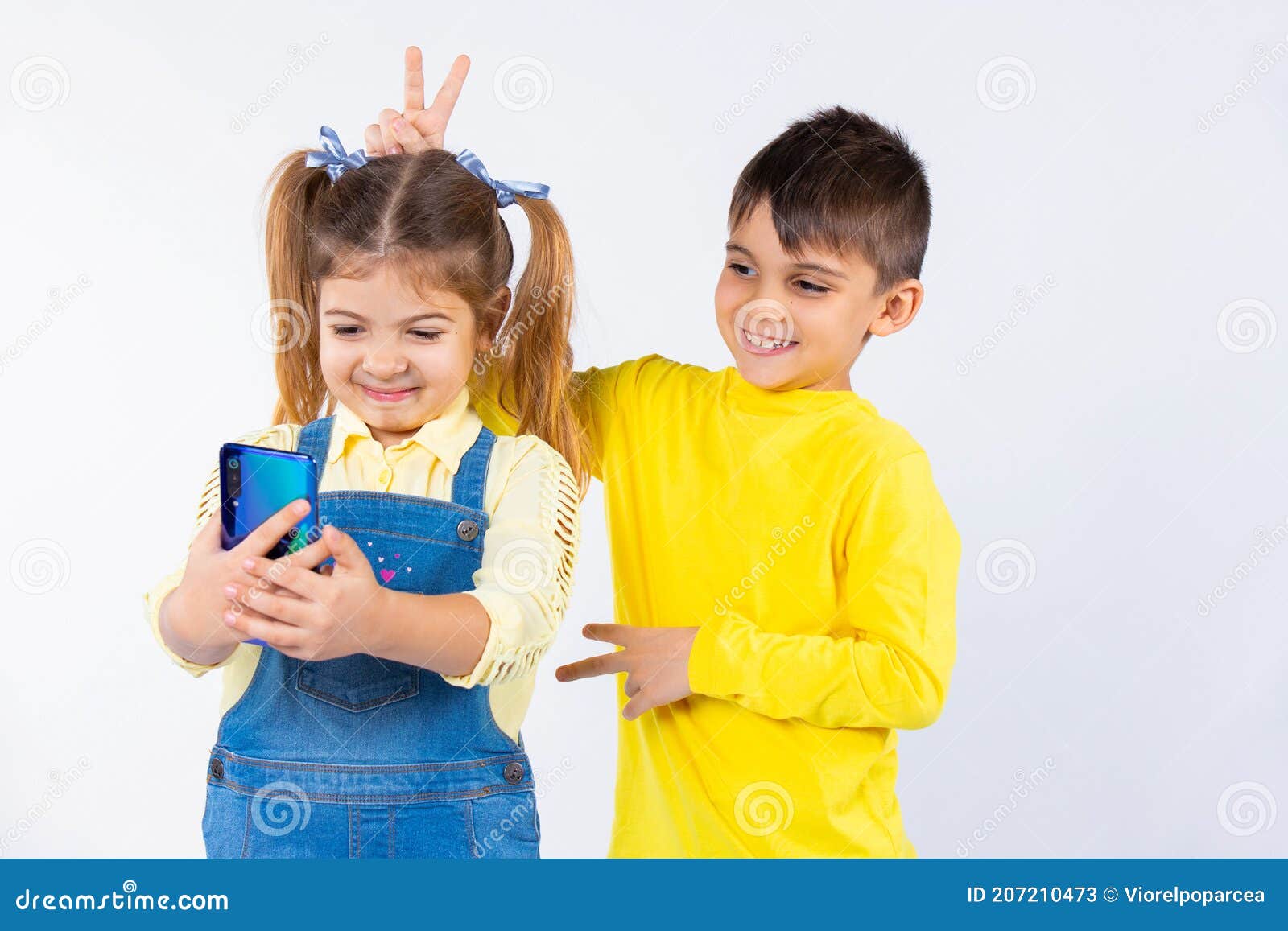 Preschool Kids Take a Selfie on a Smartphone. the Boy Puts Horns To the ...