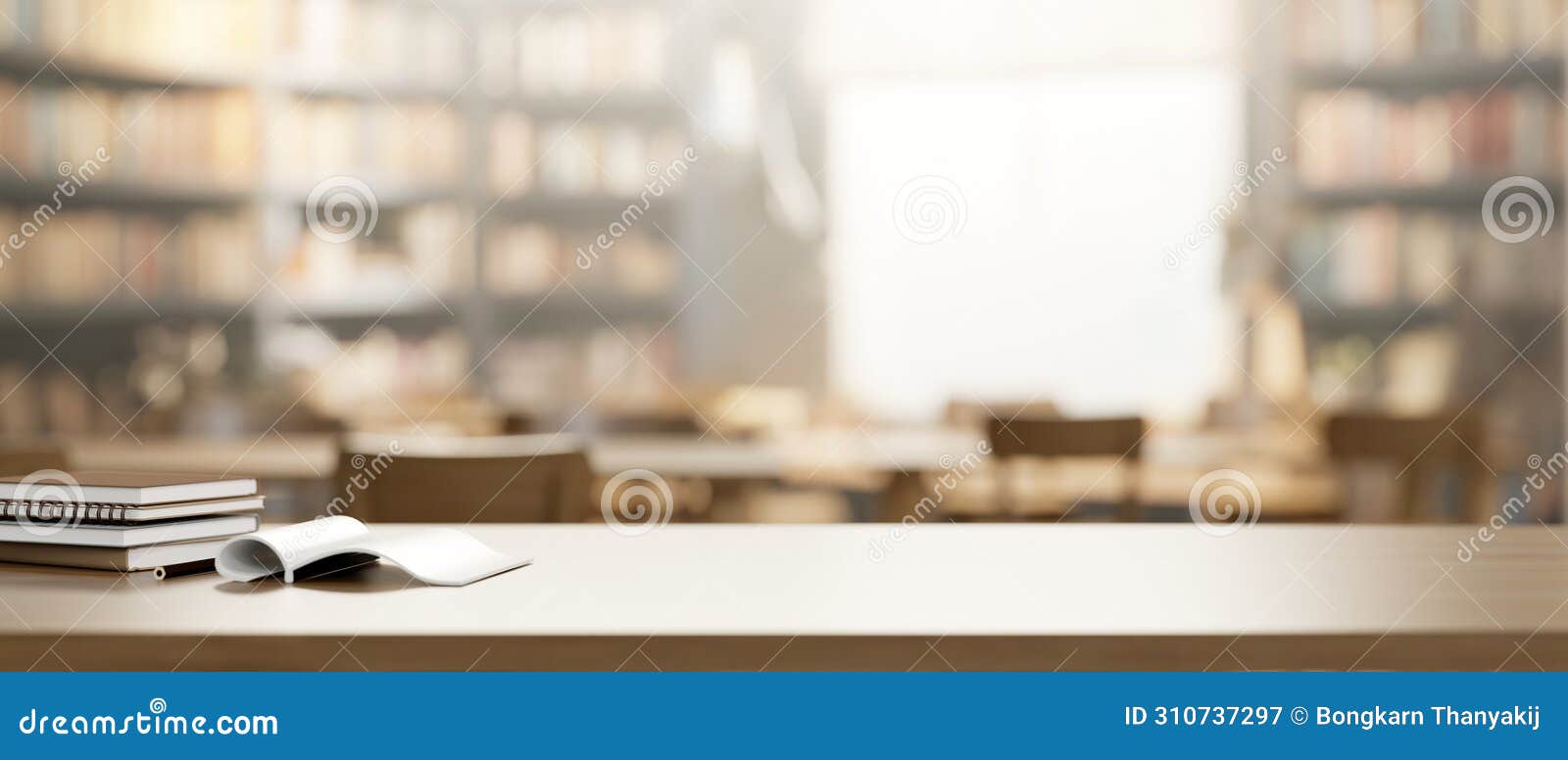 a presentation space and books on a wooden table with a blurred background of a vintage library