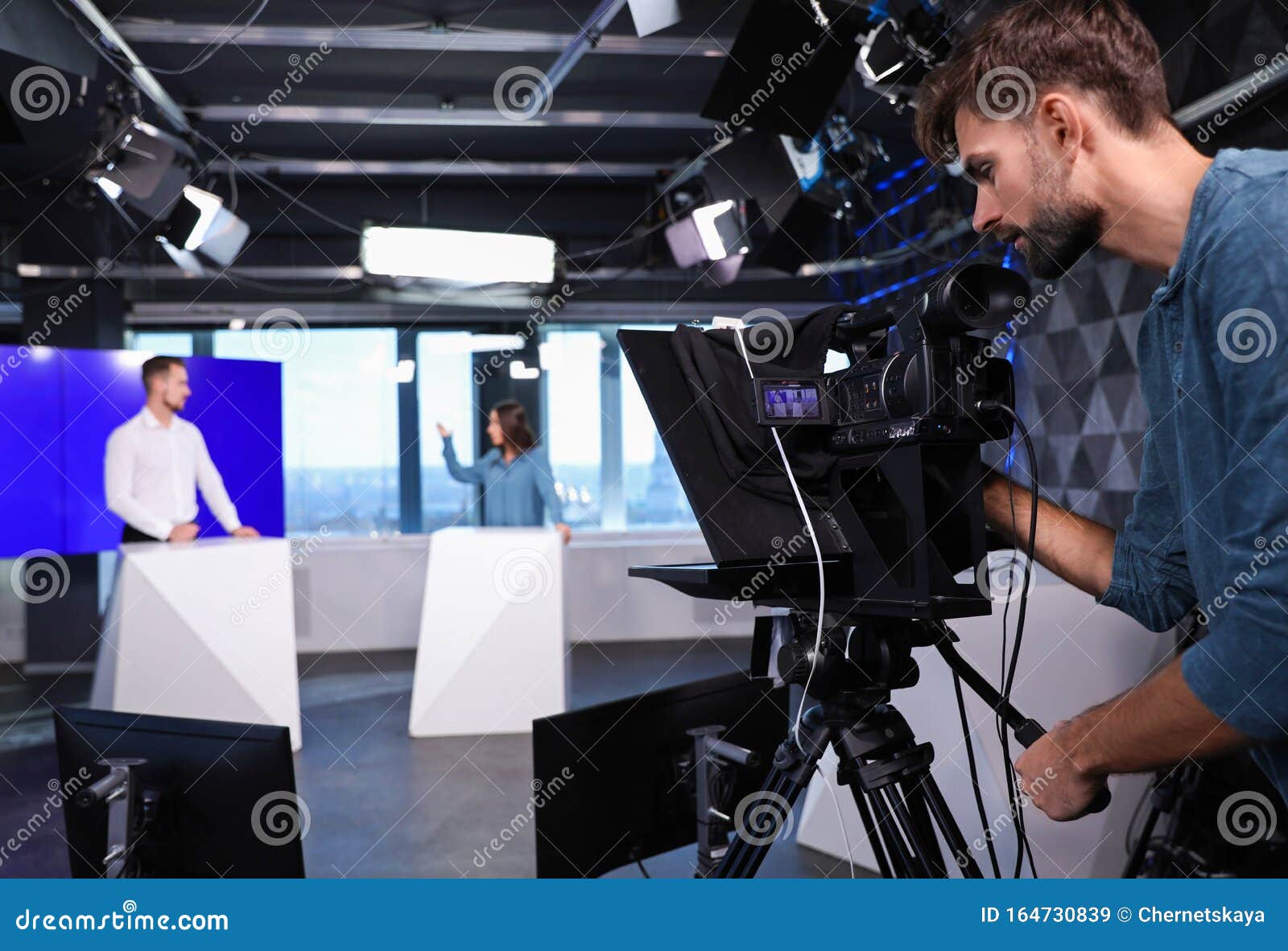 Presenters and Video Camera Operator Working. News Broadcasting Stock