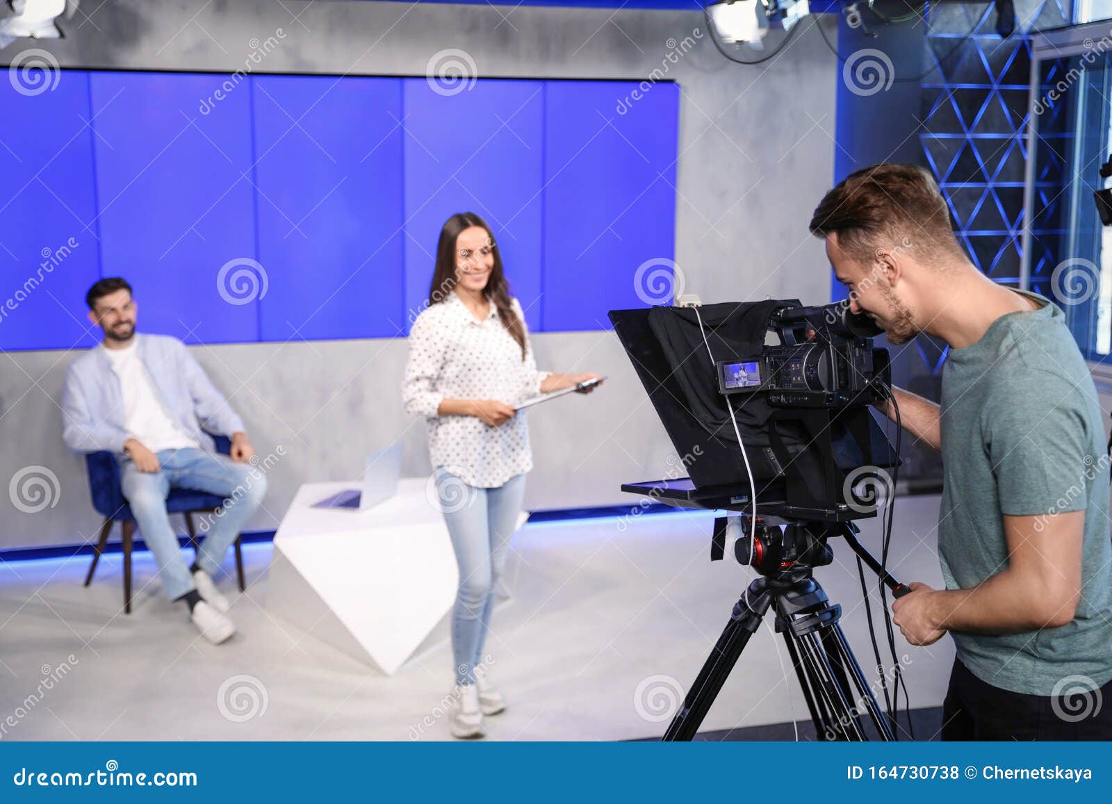 presenters and video camera operator working. news broadcasting