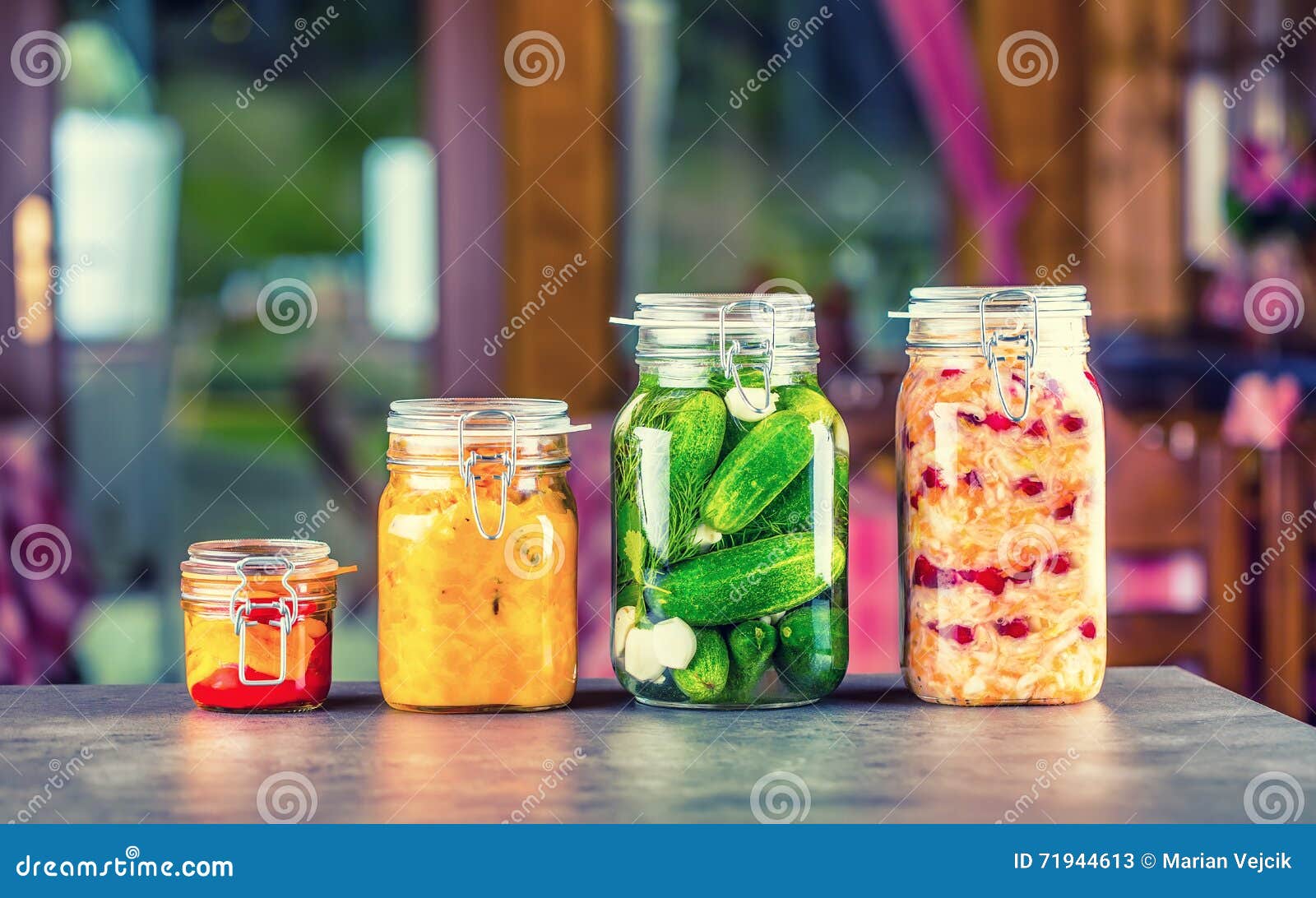 preserving. pickles jars. jars with pickles, pumpkin dip, white cabbage, roasted red yellow pepper. pickled vegetables.