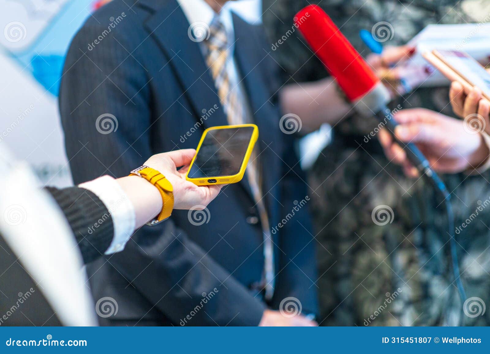 press conference, news reporters interviewing unrecognizable politician or business person during media event