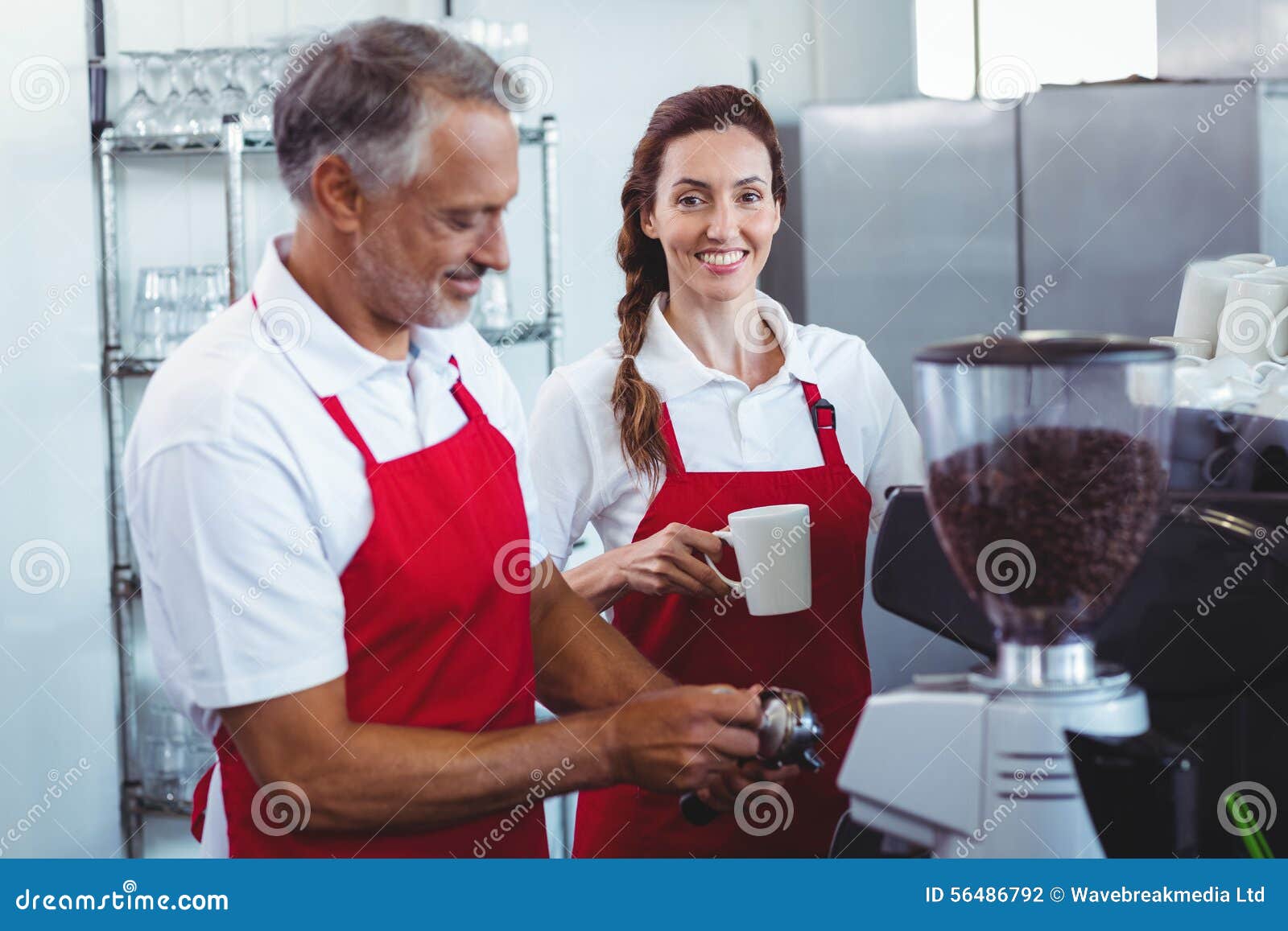 Pretty Barista Looking at Camera and Holding a Mug of Coffee Stock Photo Image of people