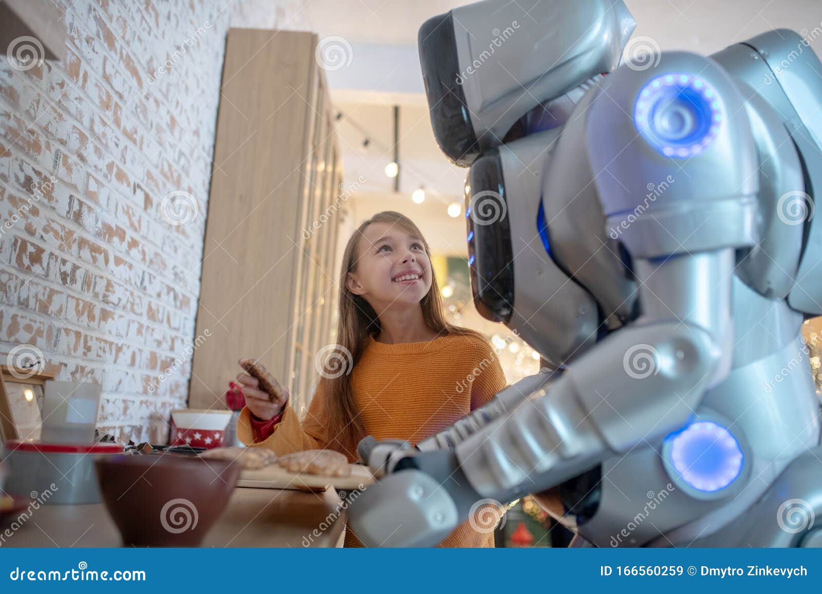 pretty beaming girl looking at house robot