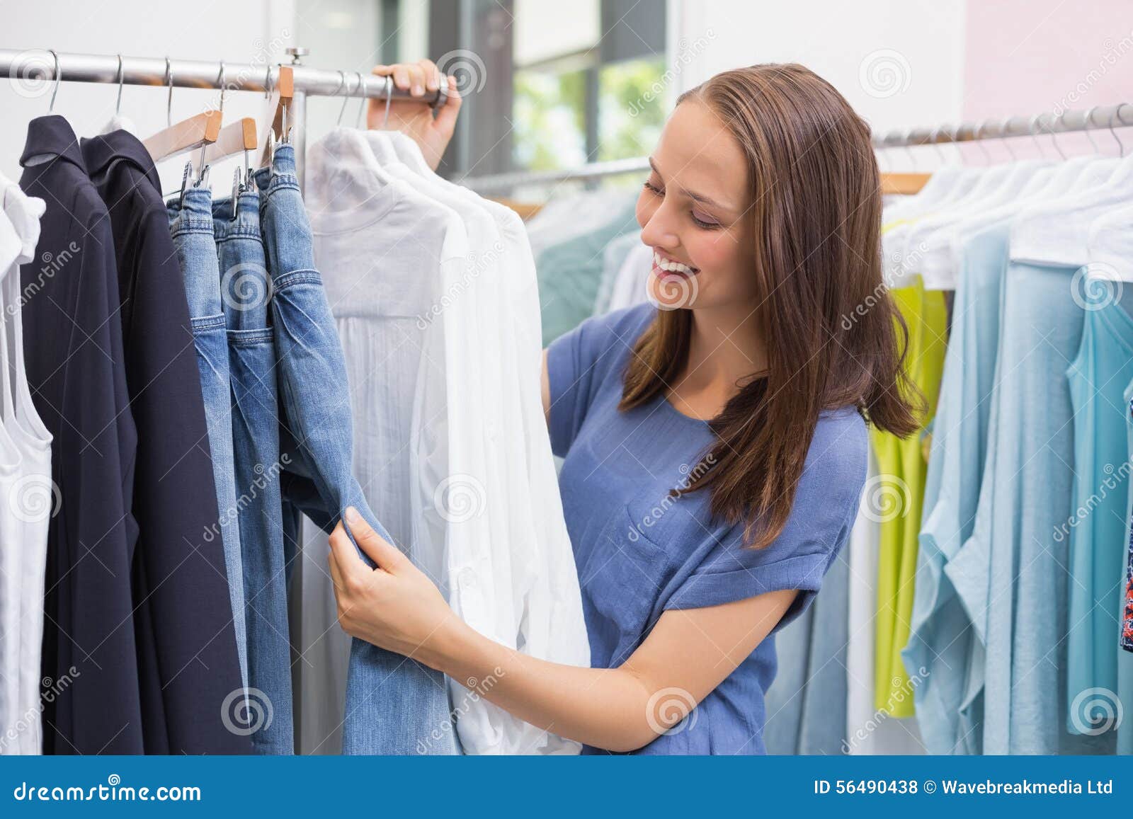 Pretty Brunette Browsing in the Clothes Rack Stock Photo - Image of ...