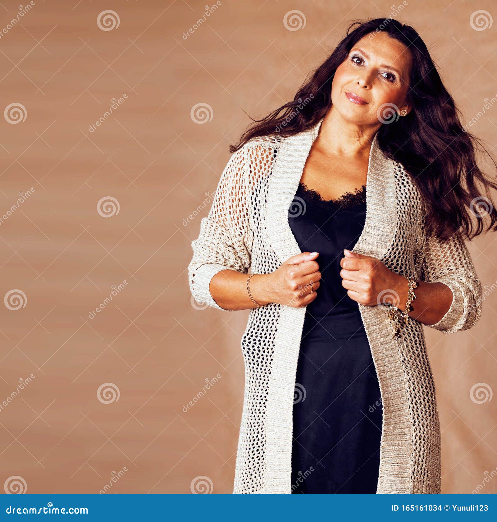 Pretty Brunette Confident Mature Woman Posing Cheerful On Warm Brown