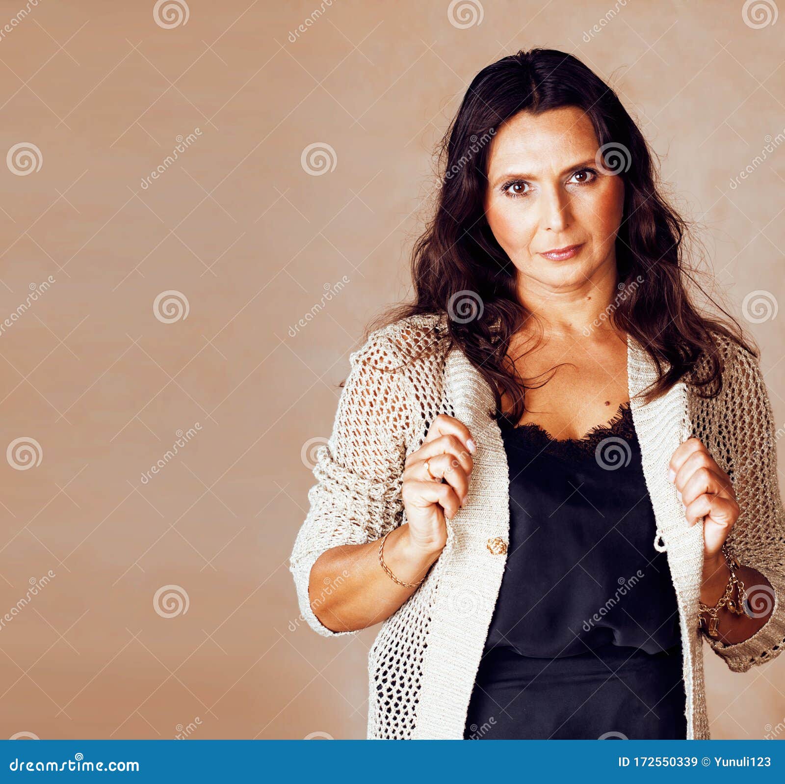 Pretty Brunette Confident Mature Woman Posing Cheerful On Warm Brown 