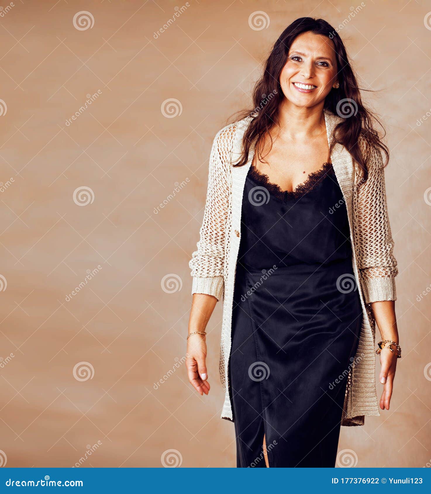 Pretty Brunette Confident Mature Woman Posing Cheerful On Warm Brown