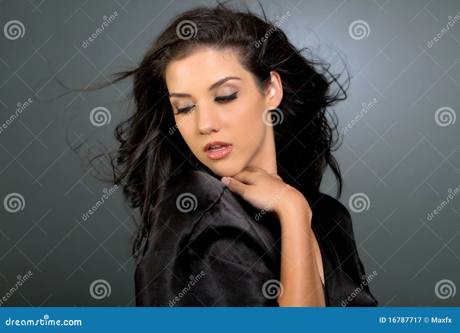 Pretty Brunette Woman Sitting By Table Inside Bakery Looking At Bread