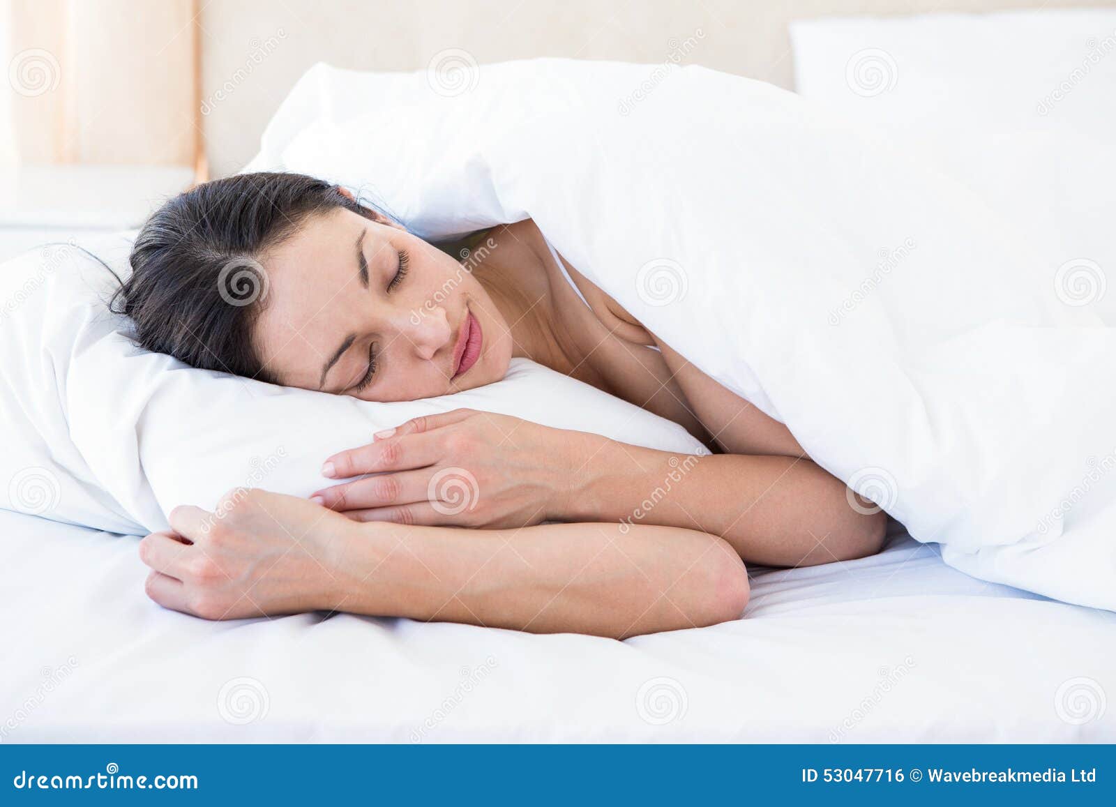 pretty brunette sleeping on bed