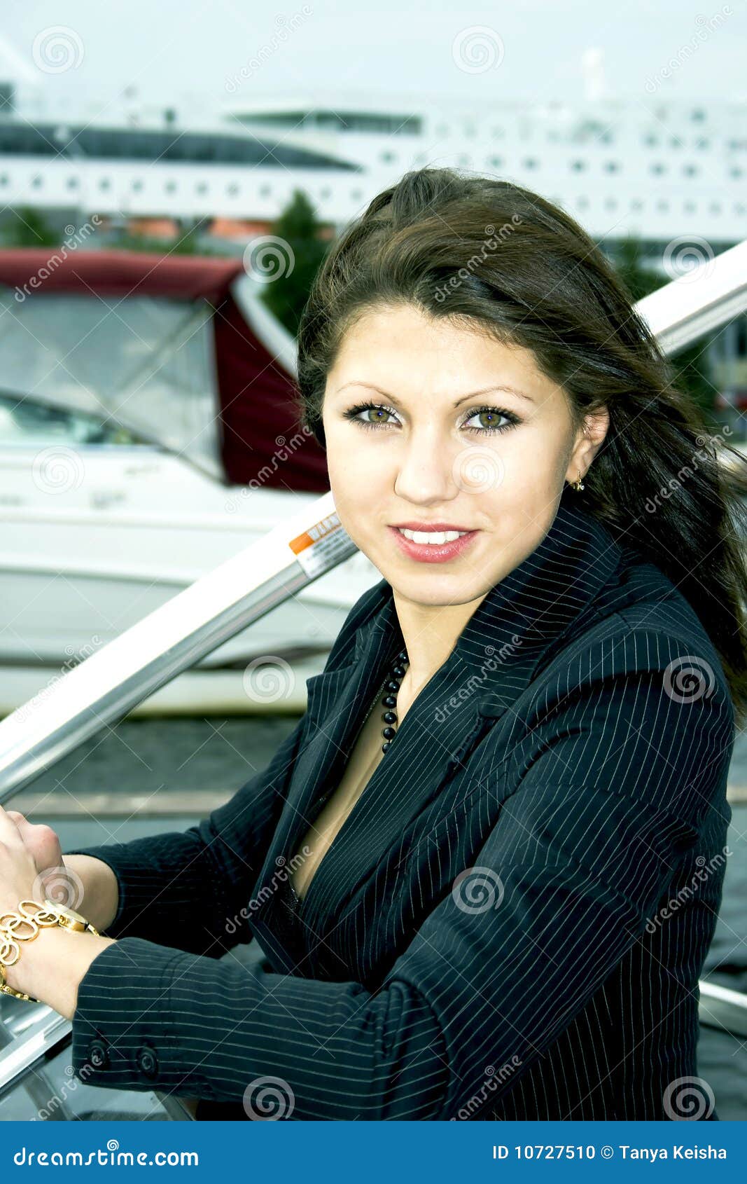 Pretty businesswoman on background of big cruise liner