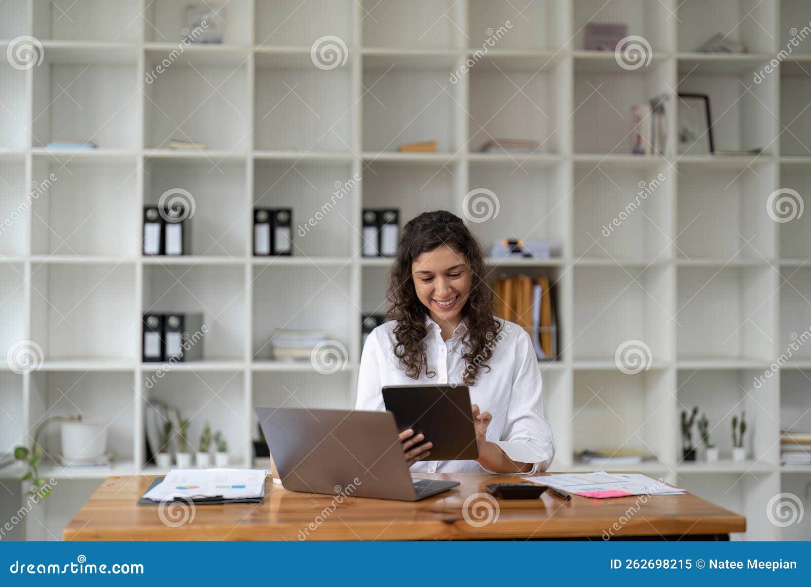 pretty, charming woman using, browsing, typing, searching, expertising, working online on computer and tablet in