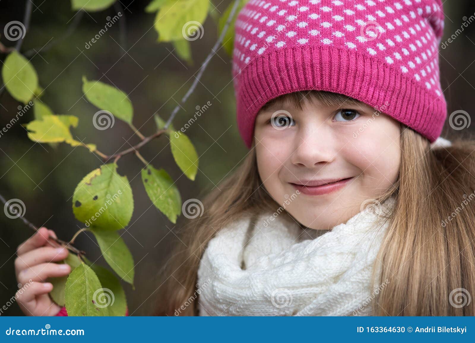 Pretty Child Girl Wearing Warm Winter Clothes Holding Tree Branch with ...
