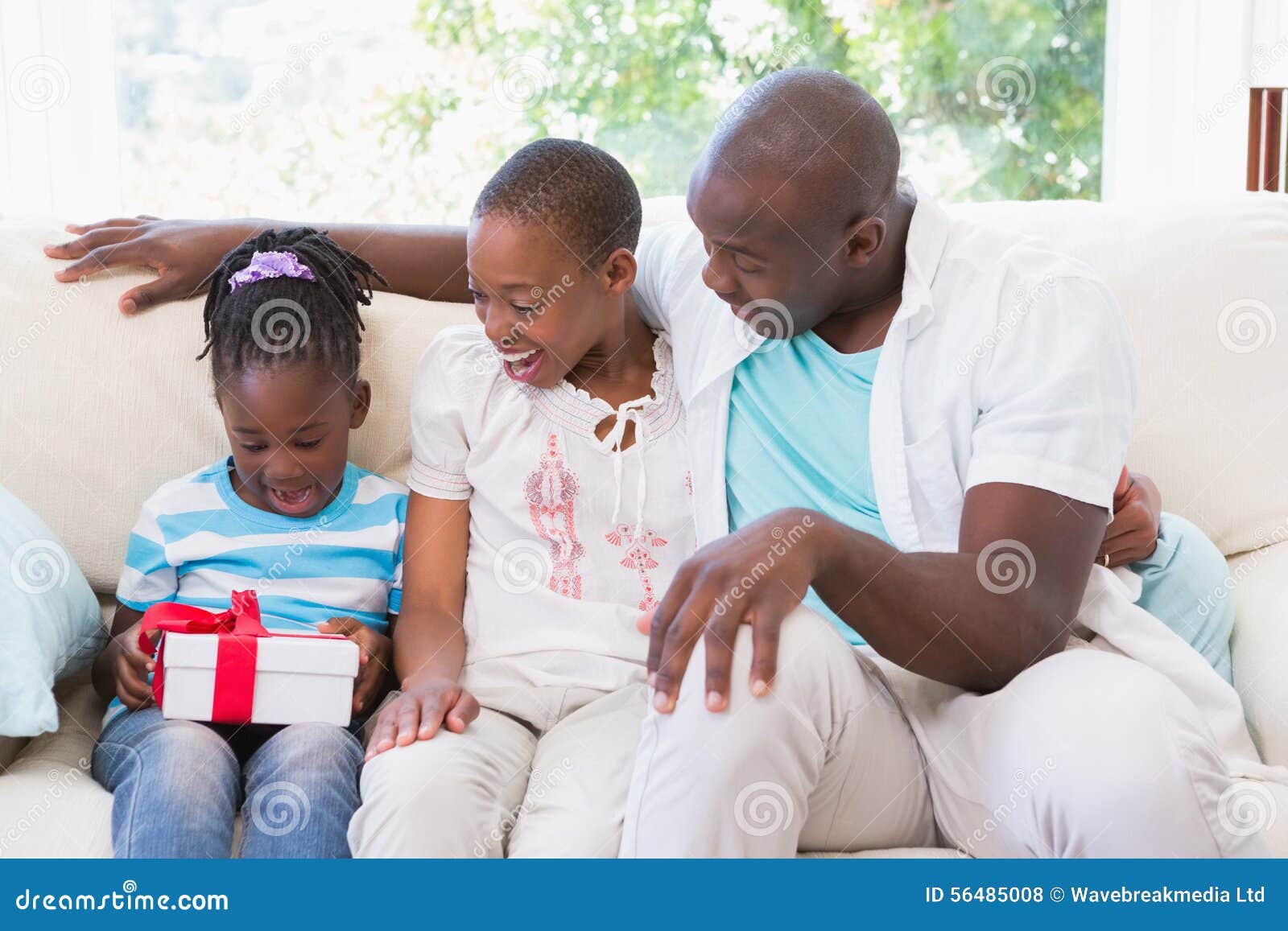 pretty couple offer a presente for their daughter