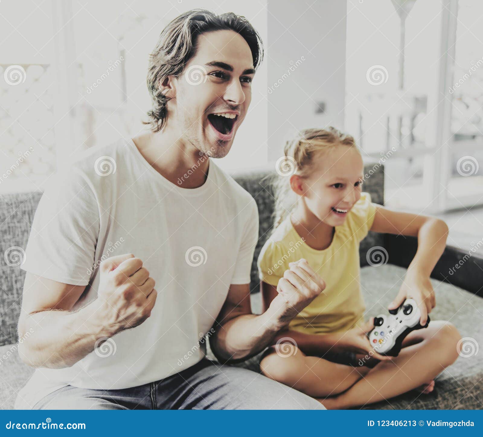 https www dreamstime com pretty father small daughter playing game console sitting couch dad cheering kid relaxing home girl digital image123406213
