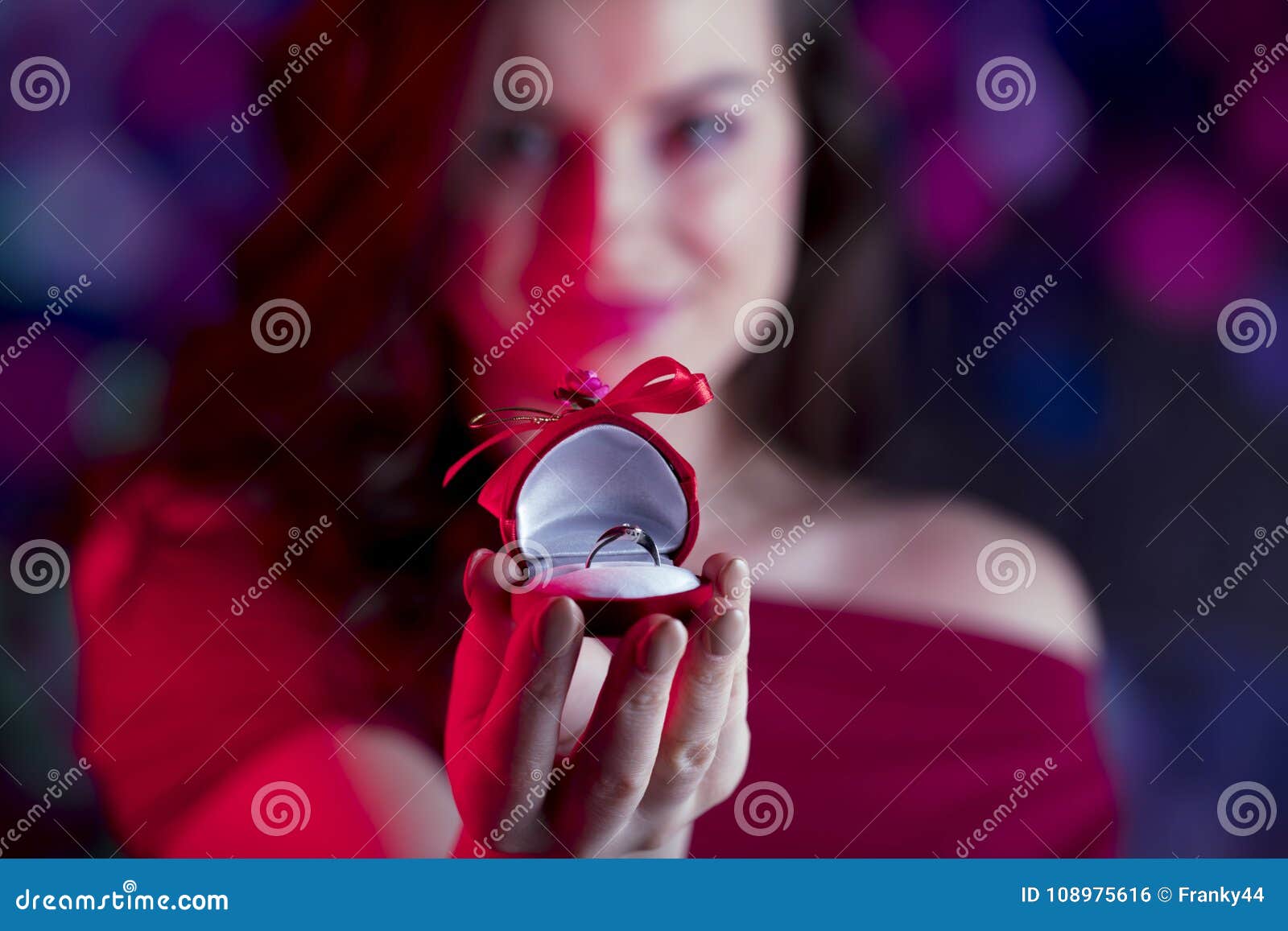 Valentines day concept. Place for typography. Pretty girl on colorful bokeh background. Valentines day symbol -red hearts. Place for text.