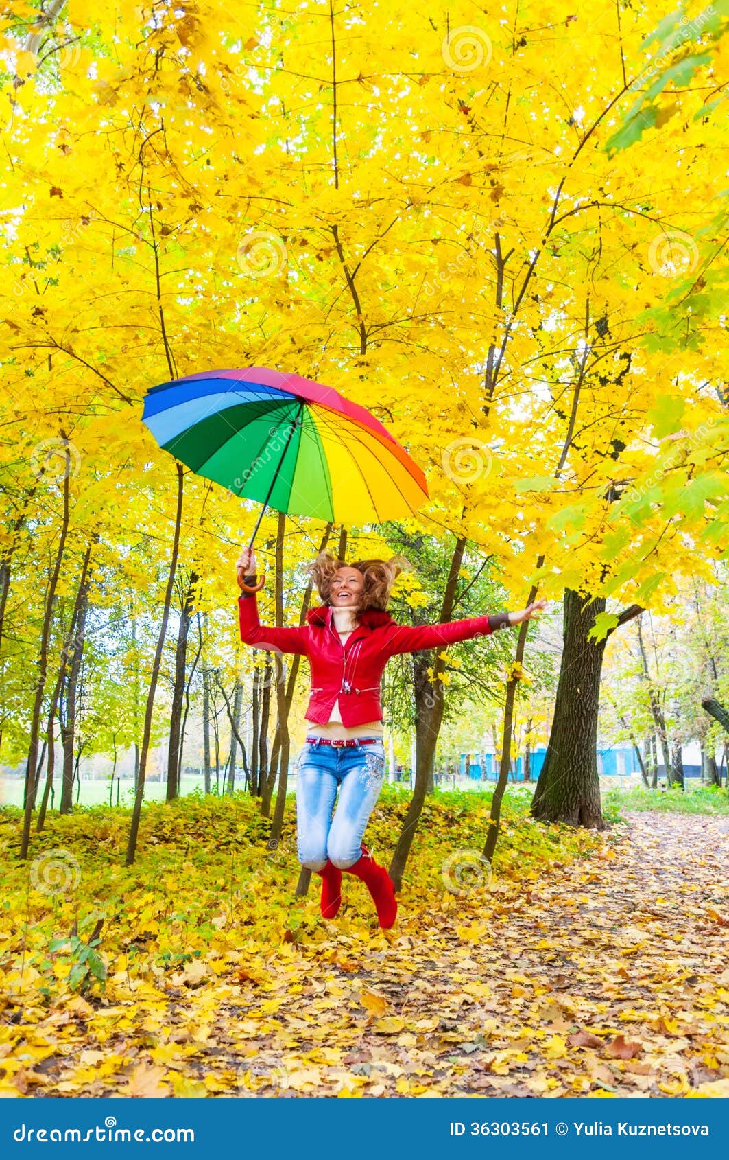 Pretty Girl With Colorful Umbrella Jumping In Autumn Park Stock Image