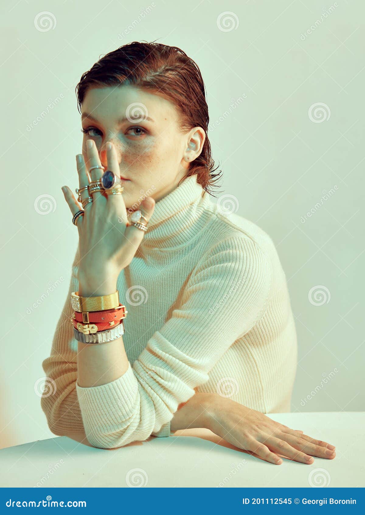 Pretty Girl With Freckles And Stylish Short Haircut Covers Her Face By Hand In Jewelleries 