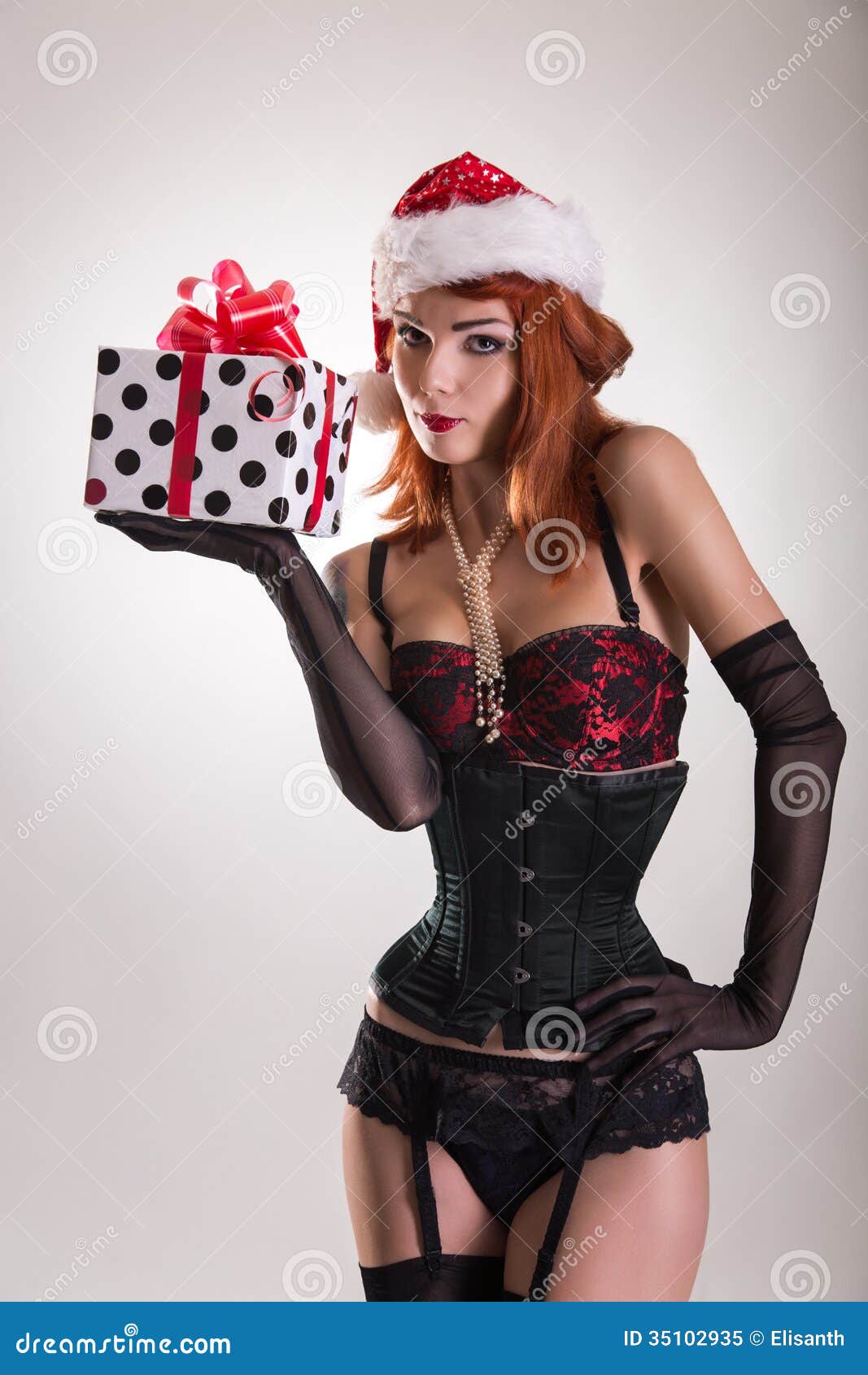 Pretty Girl Wearing Pinup Outfit And Santa Claus Hat 