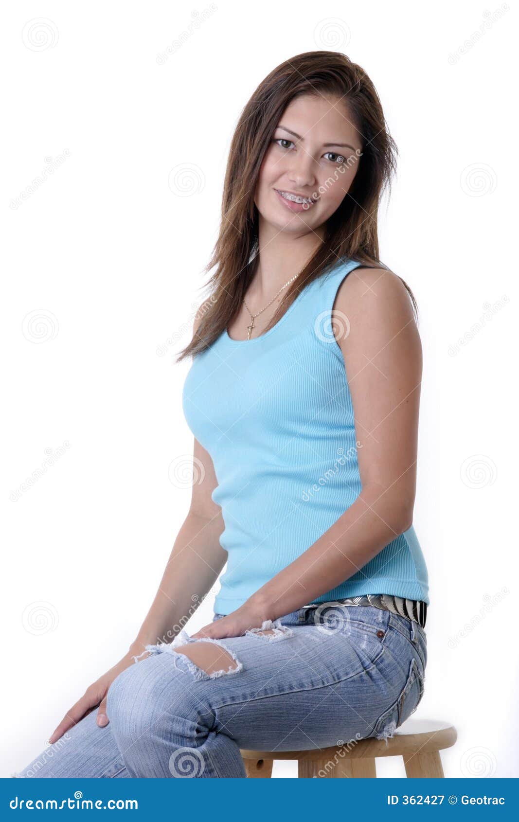 Pretty Hispanic Girl In Ripped Jeans Sitting On Stool ...